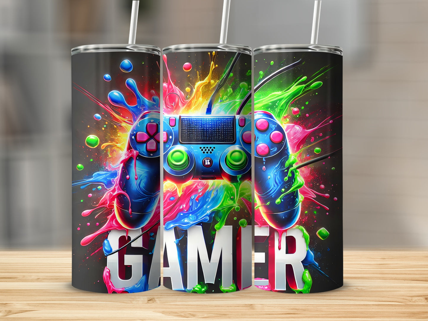 Three tumblers featuring a video game controller with colorful paint splatters and the word "GAMER".