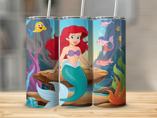 Ariel from The Little Mermaid on a blue tumbler with coral and fish.