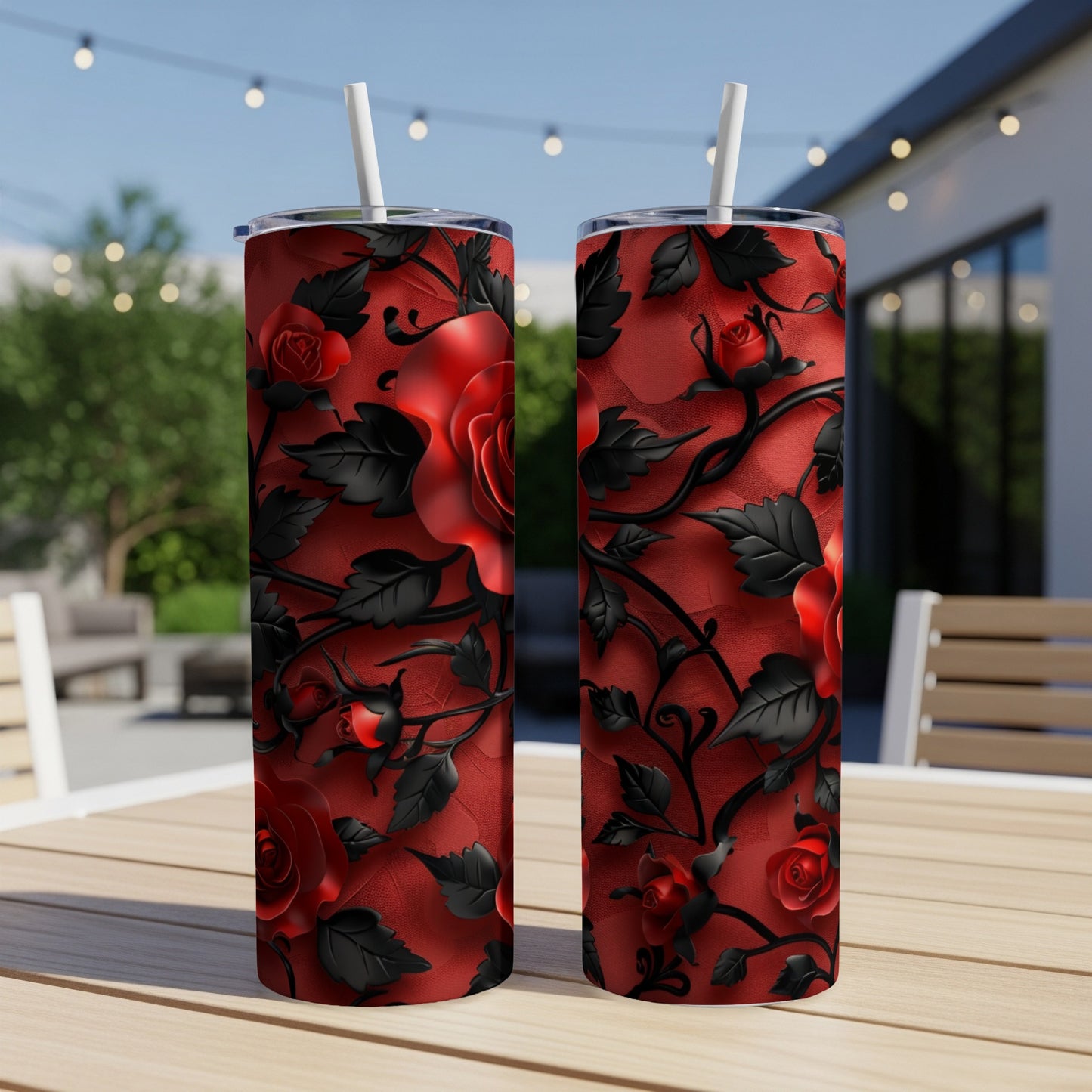 Two tall tumblers with red roses and black thorny vines on a textured background.