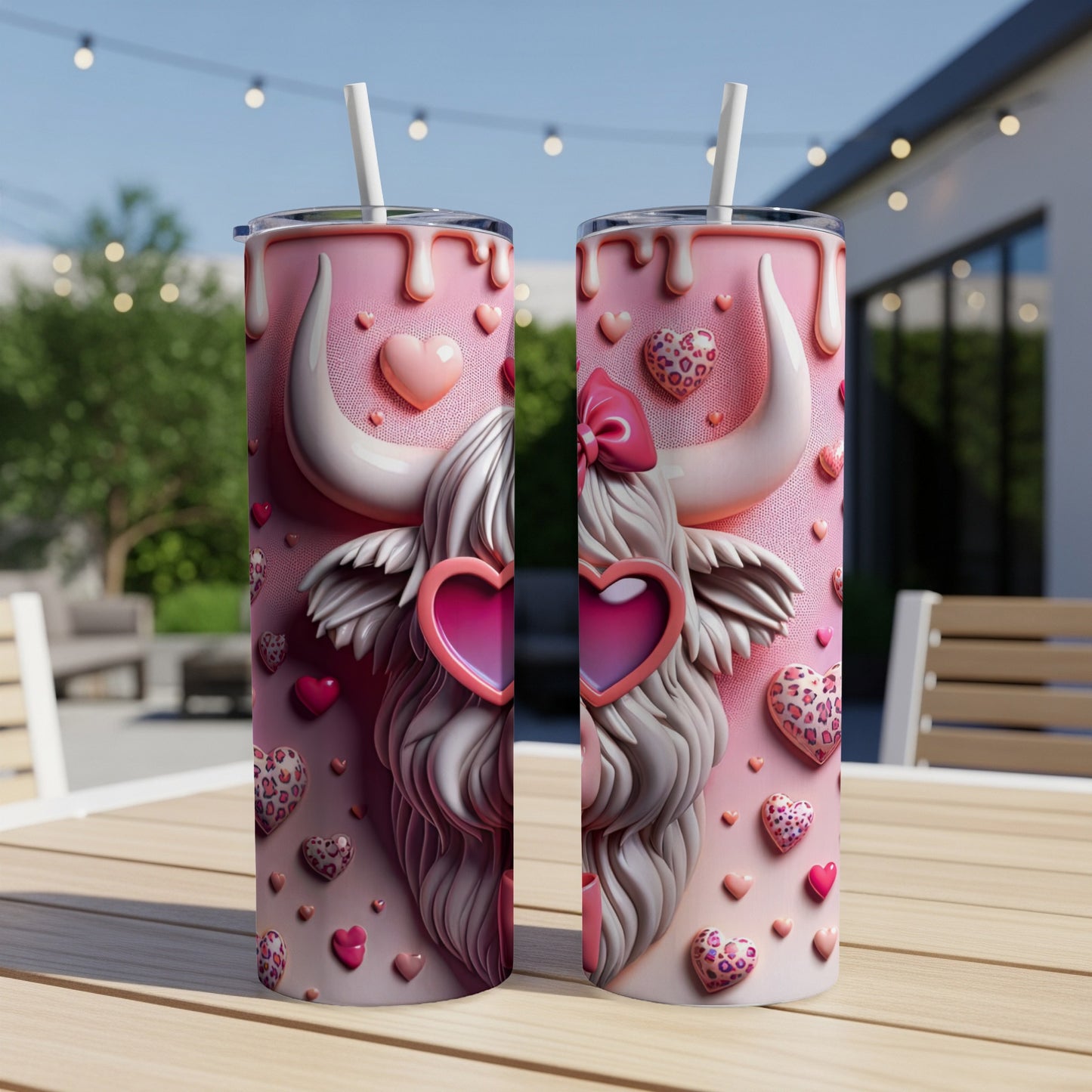Two pink Valentine's Day themed tumblers with a highland cow design and hearts.