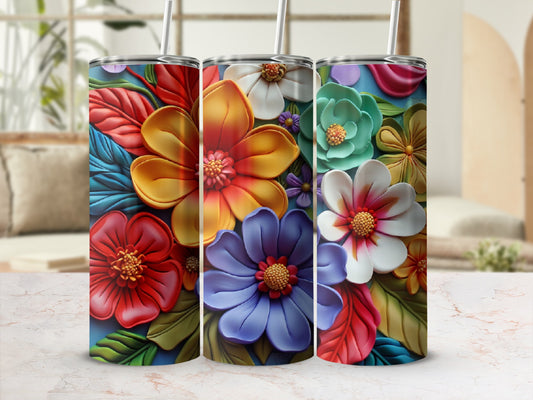 Three vibrant tumblers featuring embossed floral designs on a marbled surface.