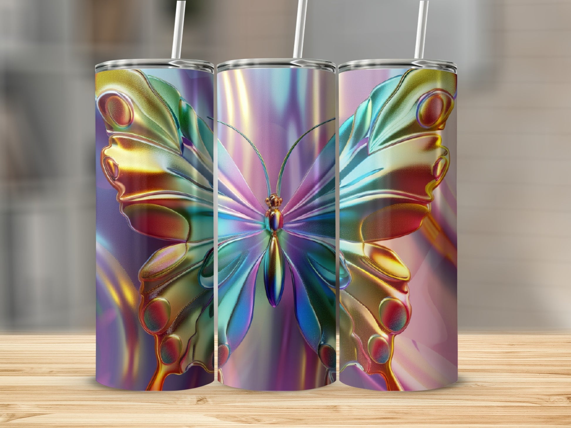 Three metallic tumblers with iridescent butterfly designs and straws.