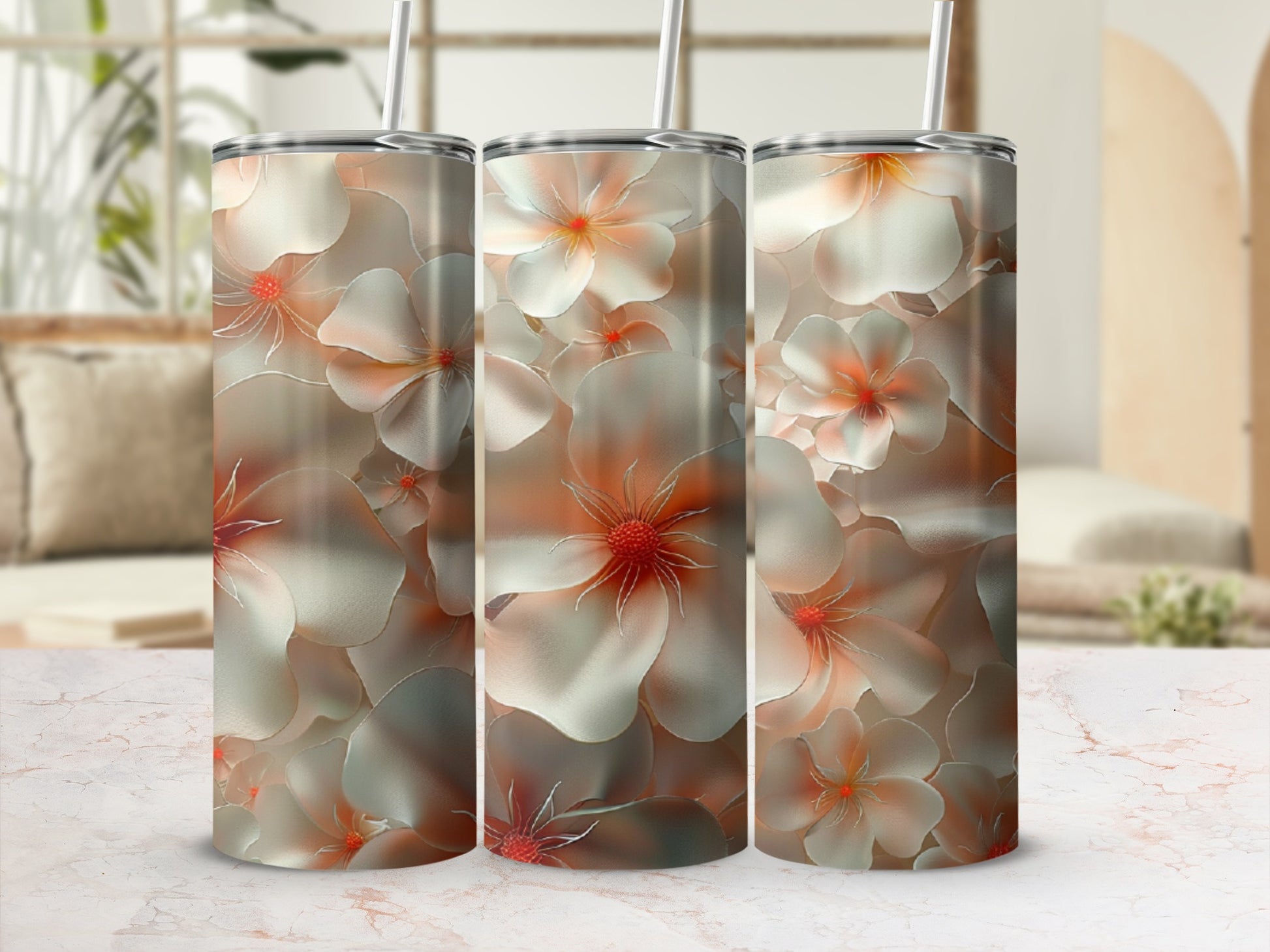 Three tumblers with a floral pattern of cream and orange flowers.