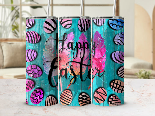 Happy Easter tumbler with patterned eggs and feathers on teal wood background.
