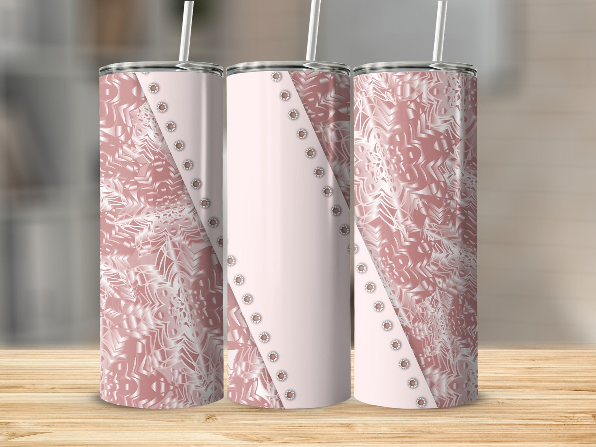 Three rose gold tumblers with white snowflake and geometric patterns.