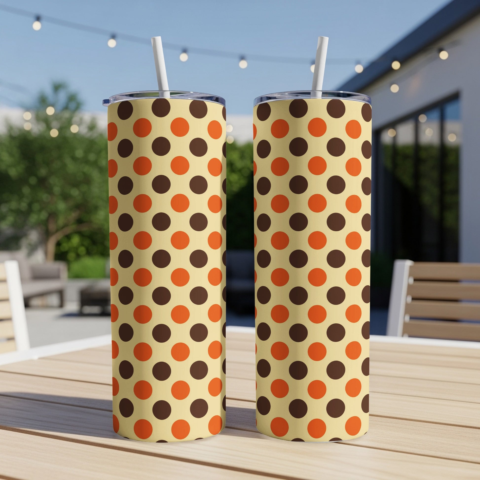 Two tumblers with cream background and a repeating pattern of brown and orange polka dots.