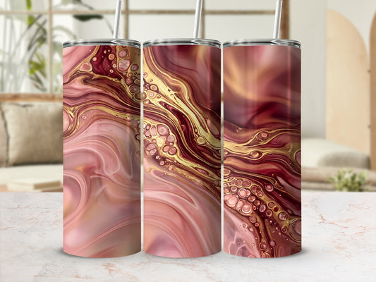 Three skinny tumblers with a pink and gold abstract marbling design.