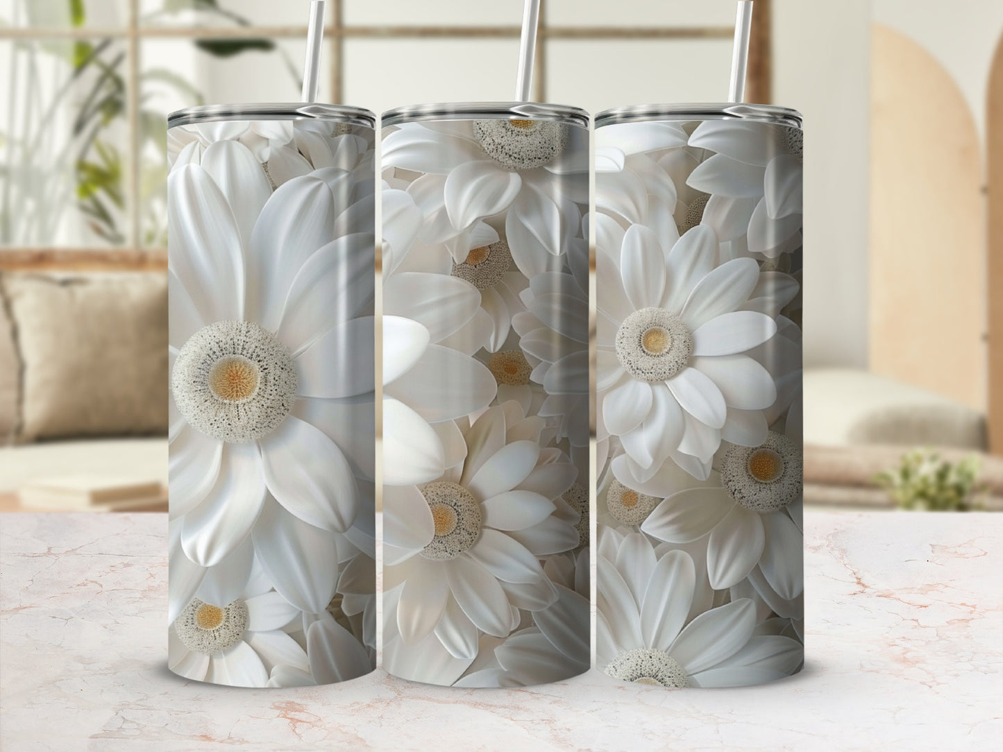 White floral pattern on a tumbler with a straw, on a marble surface.