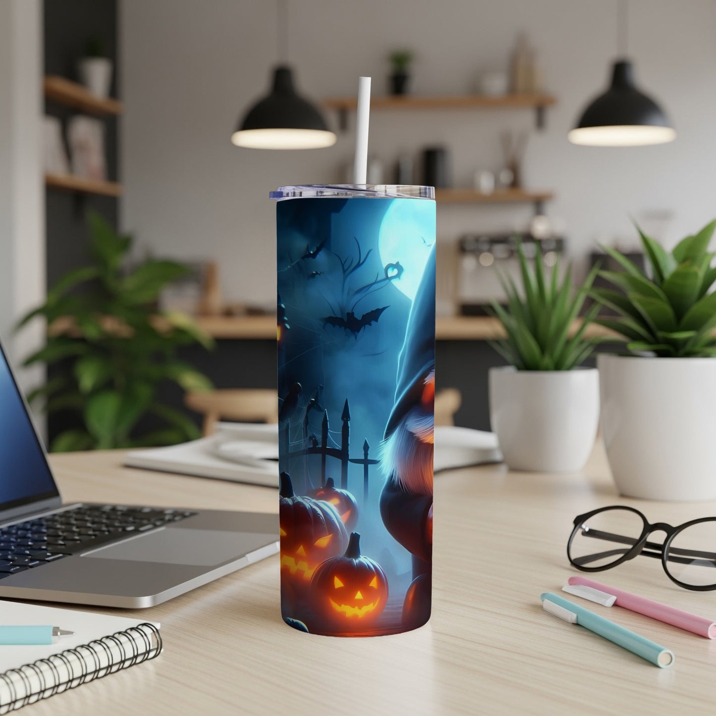 Halloween tumbler with gnome, bats, pumpkins, and moon under blue light.