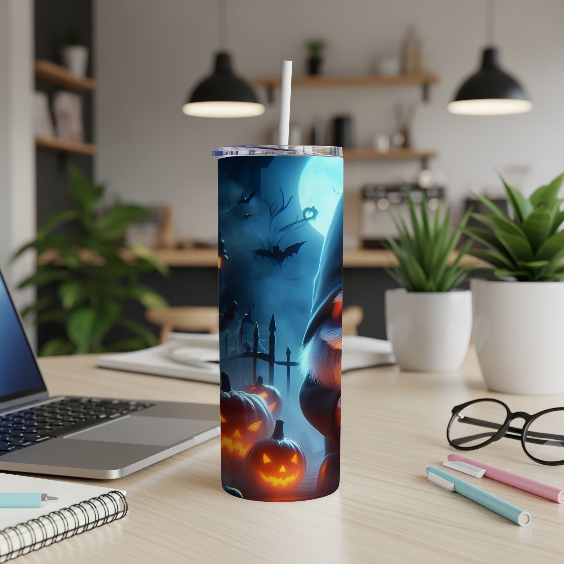 Halloween tumbler with gnome, bats, pumpkins, and moon under blue light.
