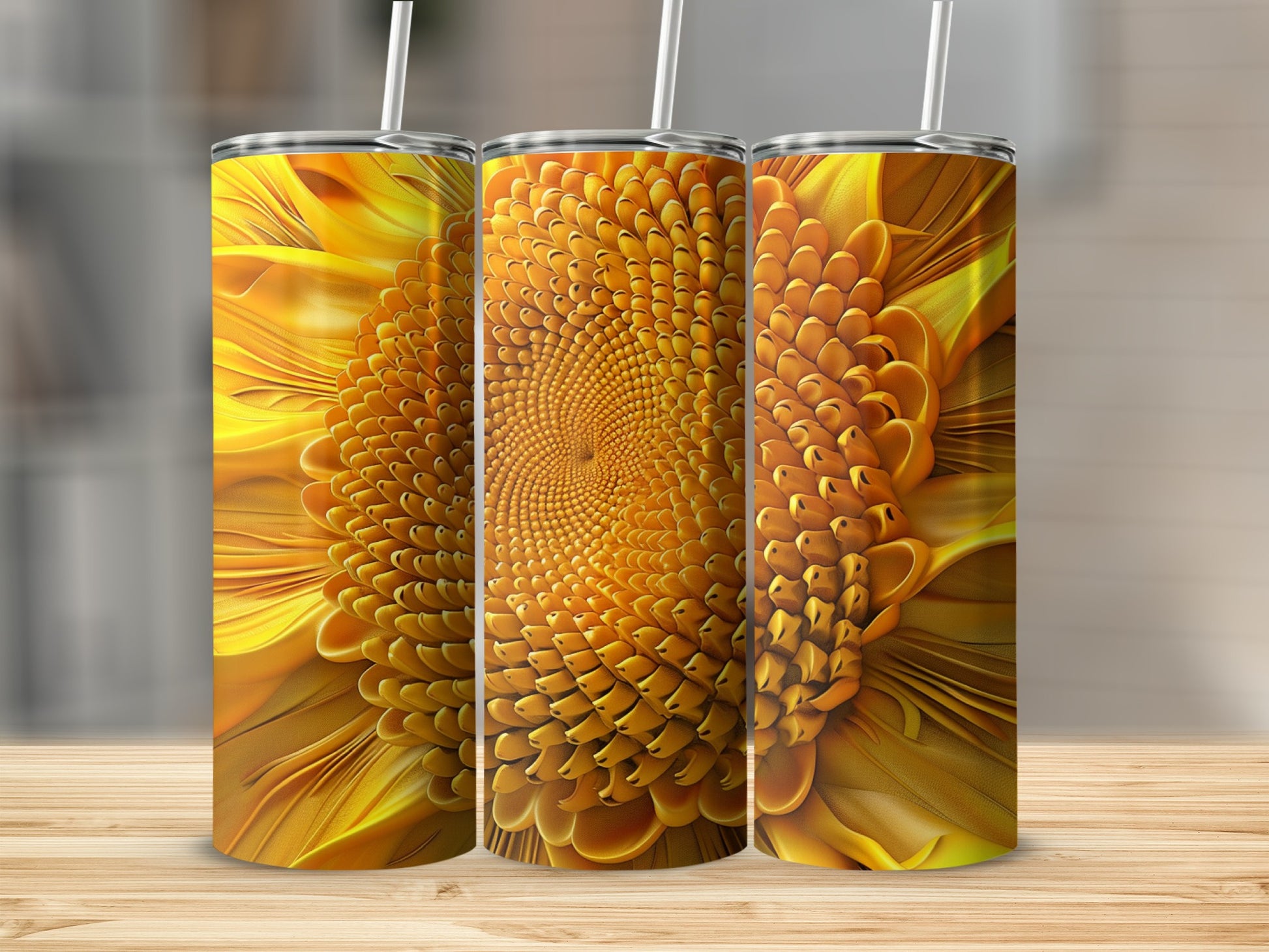Three tumblers with a detailed sunflower design, standing on a wooden surface.
