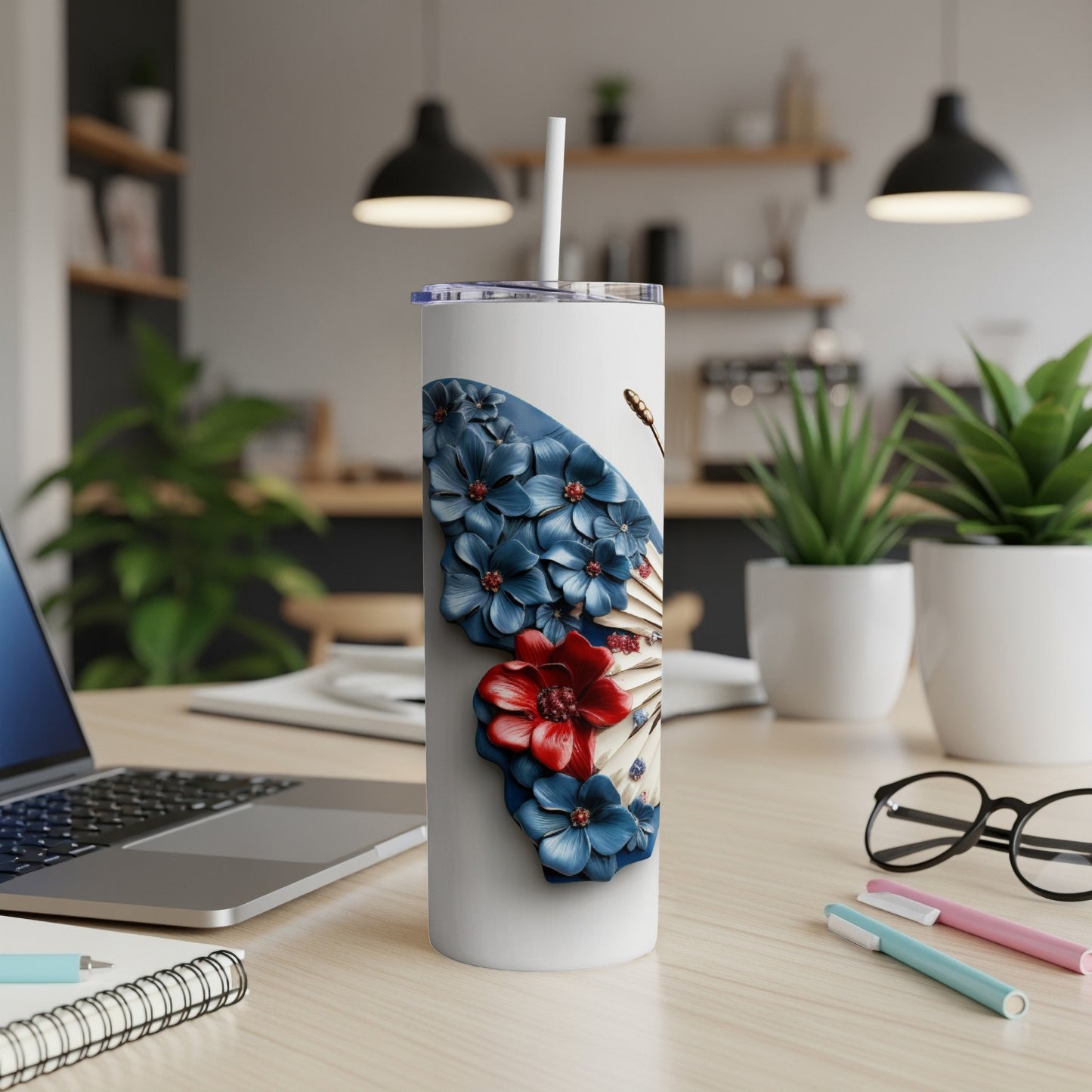 White tumbler with red, white, and blue floral butterfly design.