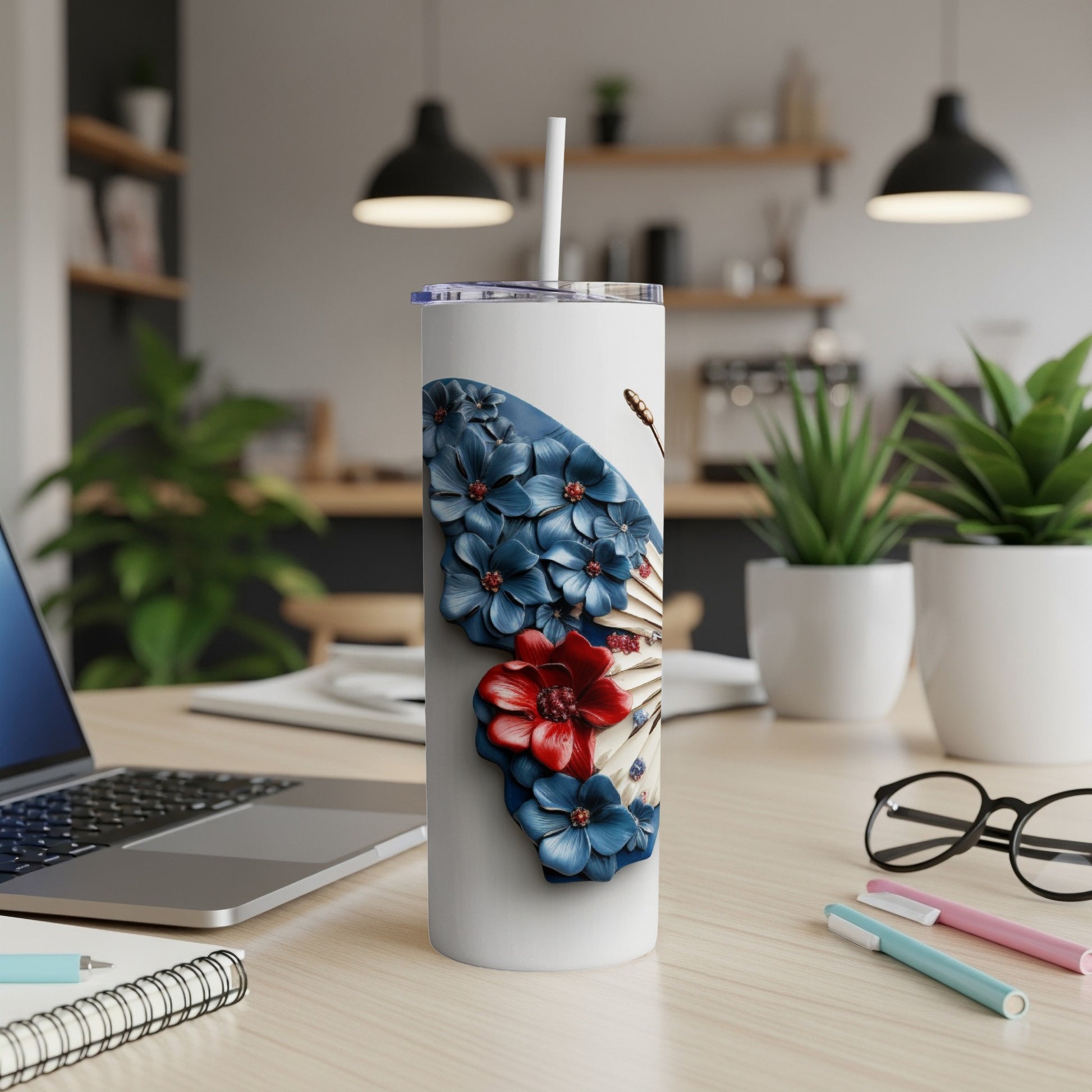 White tumbler with red, white, and blue floral butterfly design.