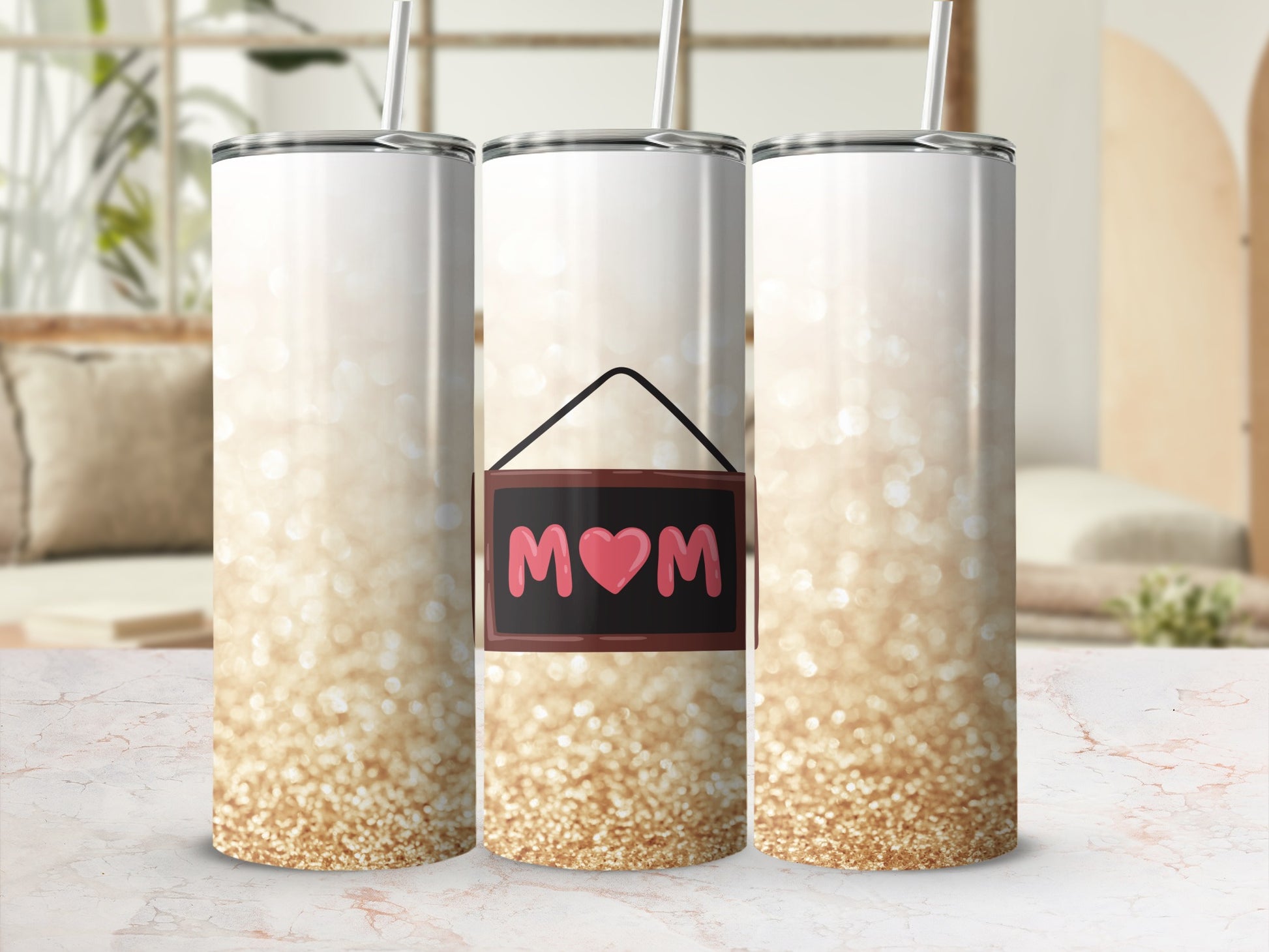 White tumbler with gold glitter design and "Mom" sign.