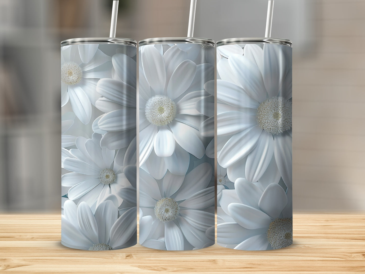 Three white daisy tumblers with straws on a wooden surface.