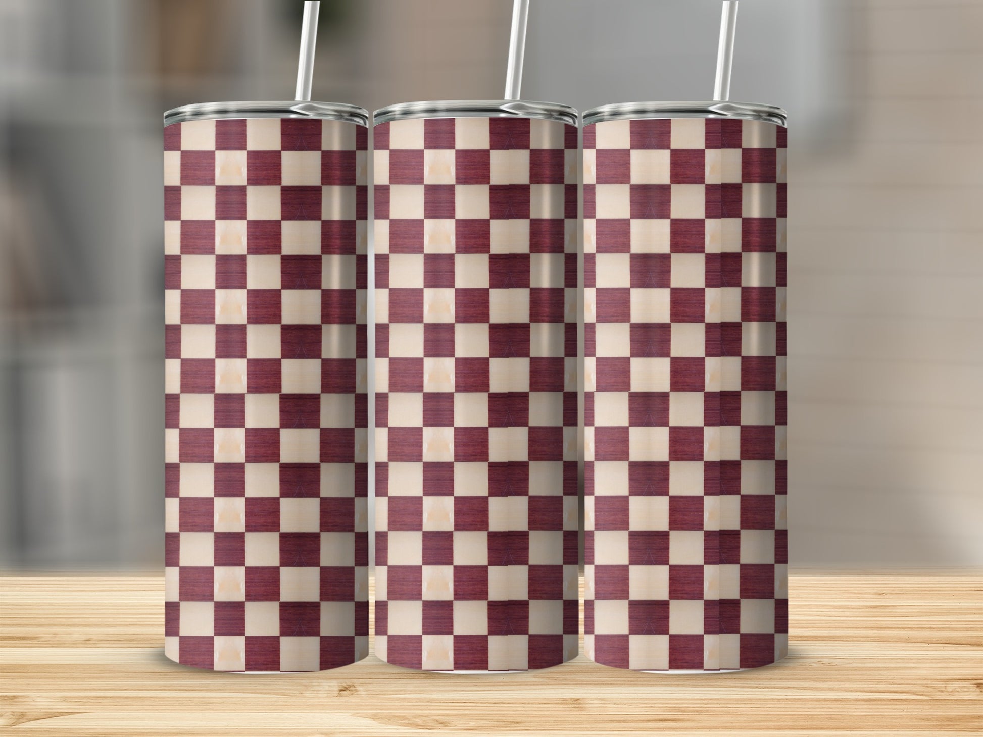 Three tall tumblers with a checkered maroon and cream pattern.