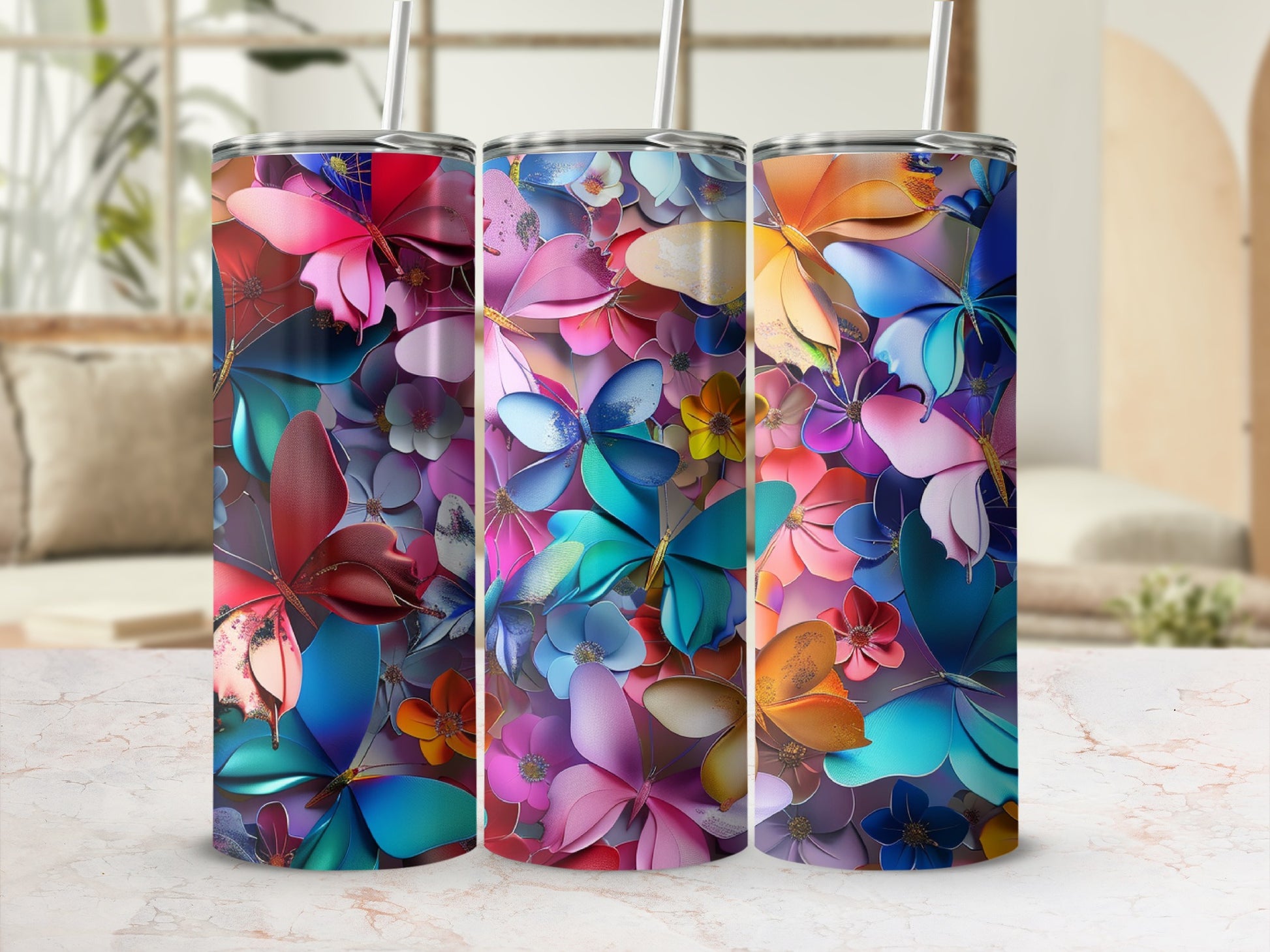 Three tumblers with colorful butterfly and floral designs.