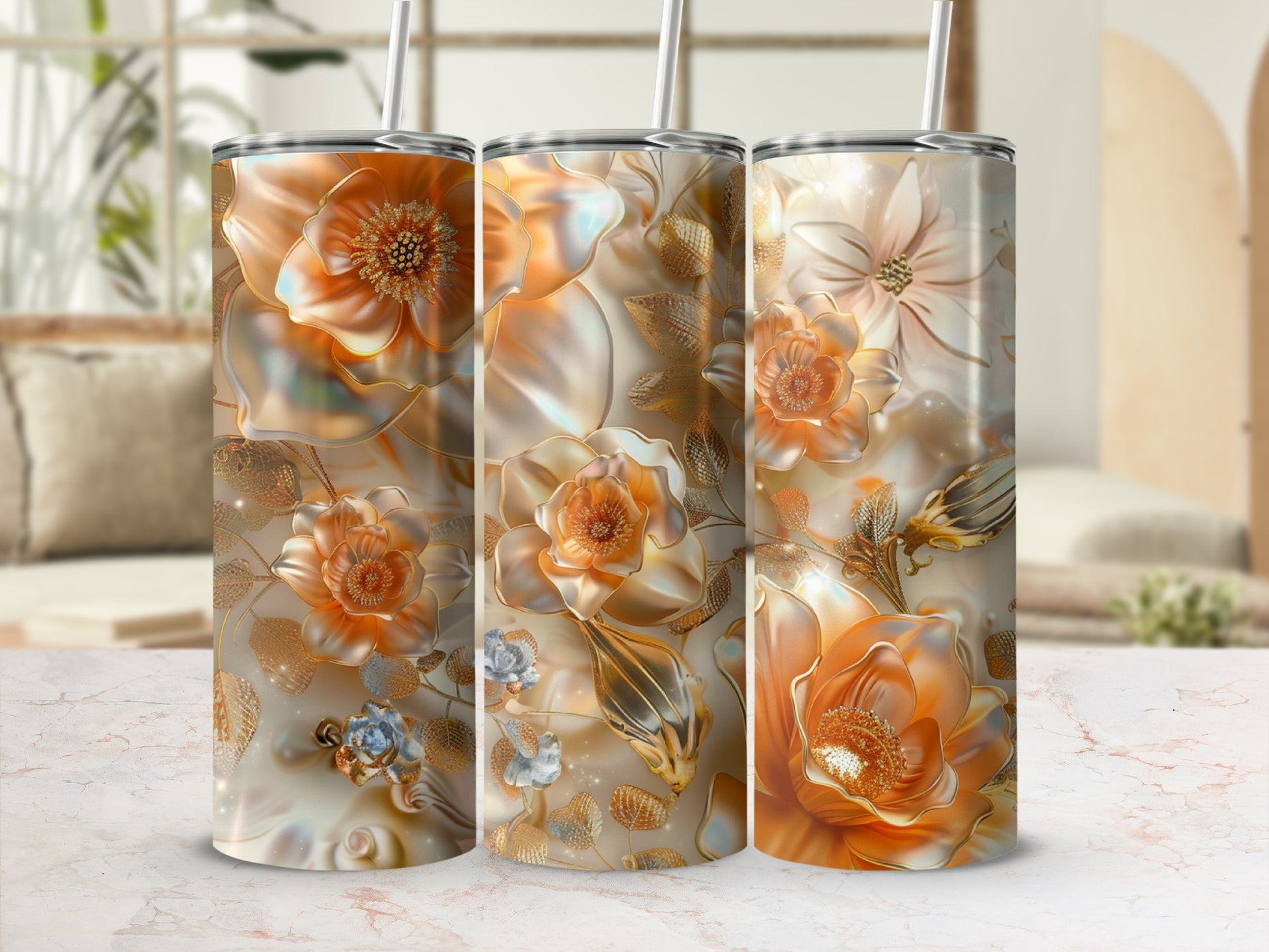 Triptych of tumblers with ornate gold floral designs on a marble surface.