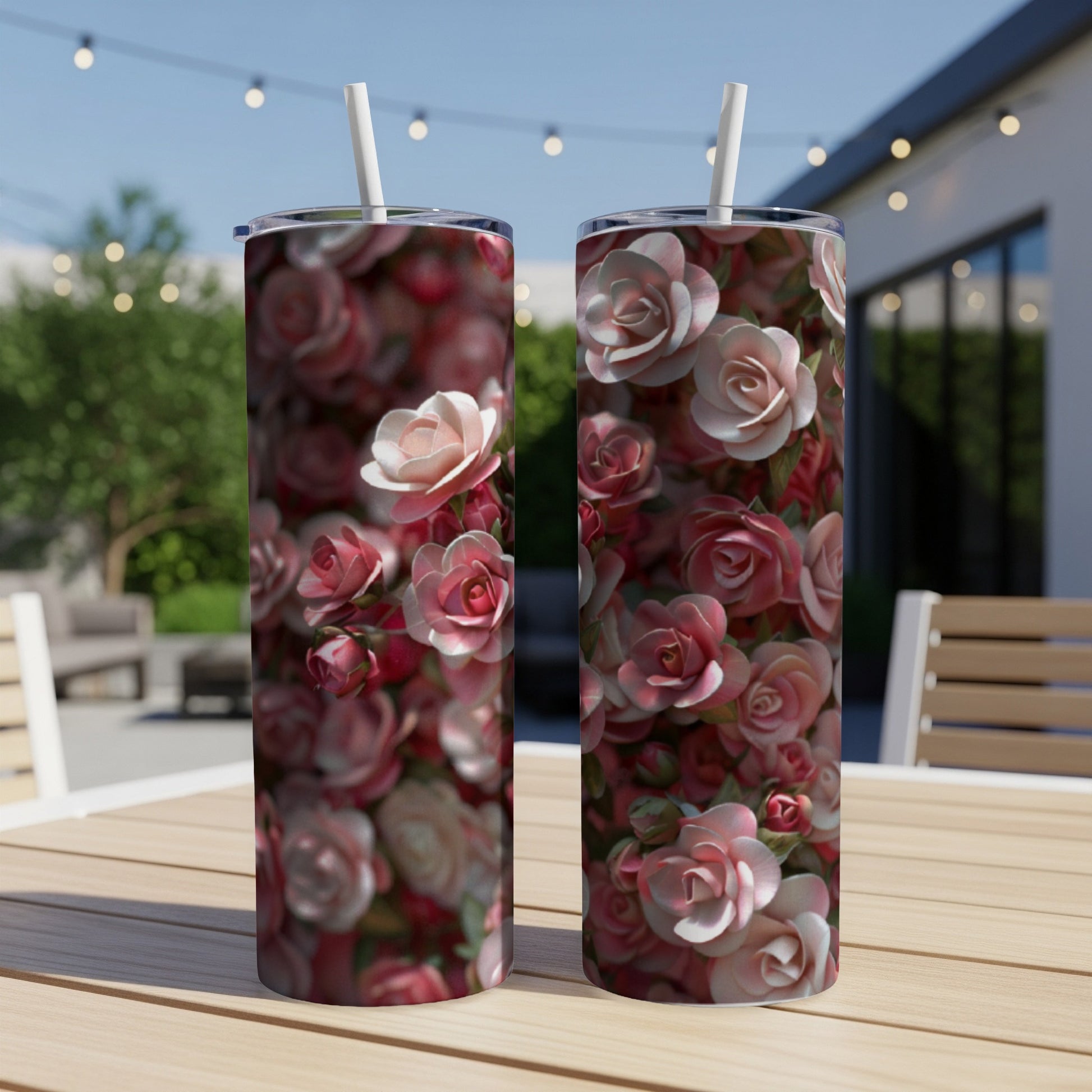 Two tumblers with a floral rose pattern on a wooden table.