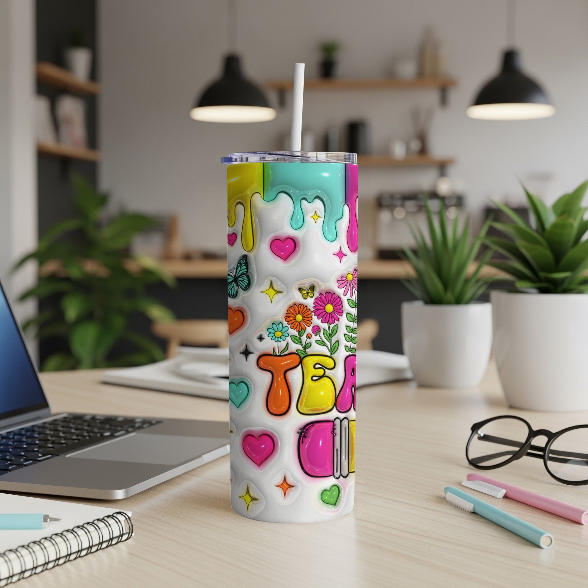 White tumbler with colorful "TEA" lettering and flower stickers.