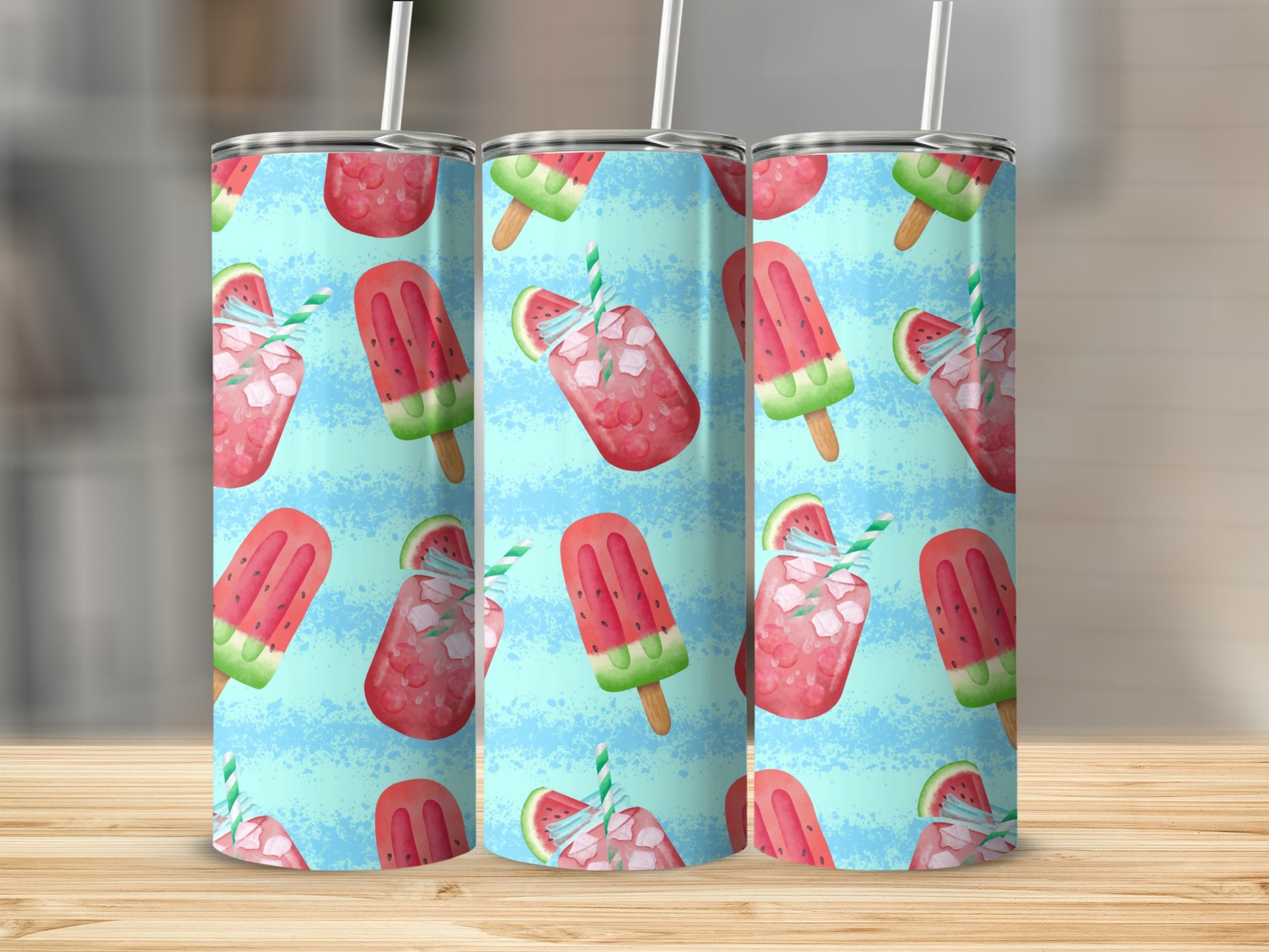Three tumblers with watermelon popsicle and slice pattern on blue background.