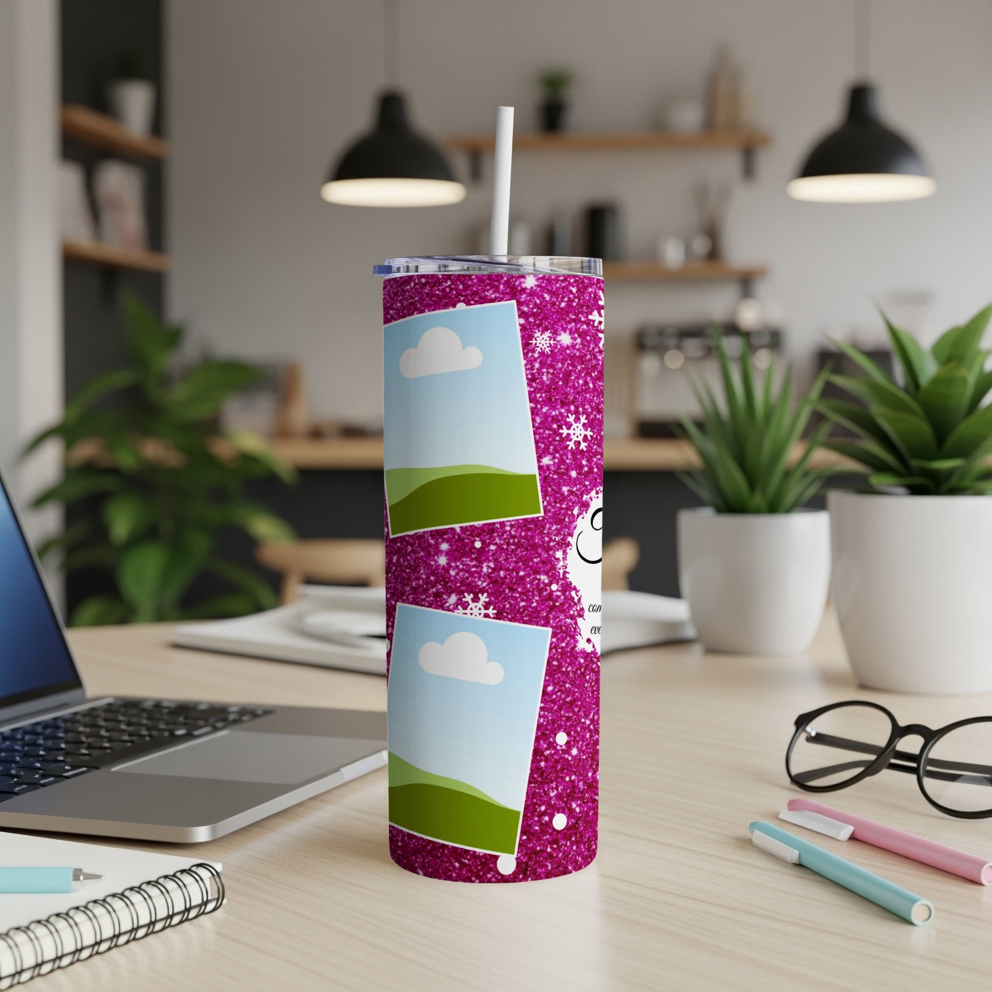Pink glitter tumbler with photo frames and snowflakes, sitting on a desk.