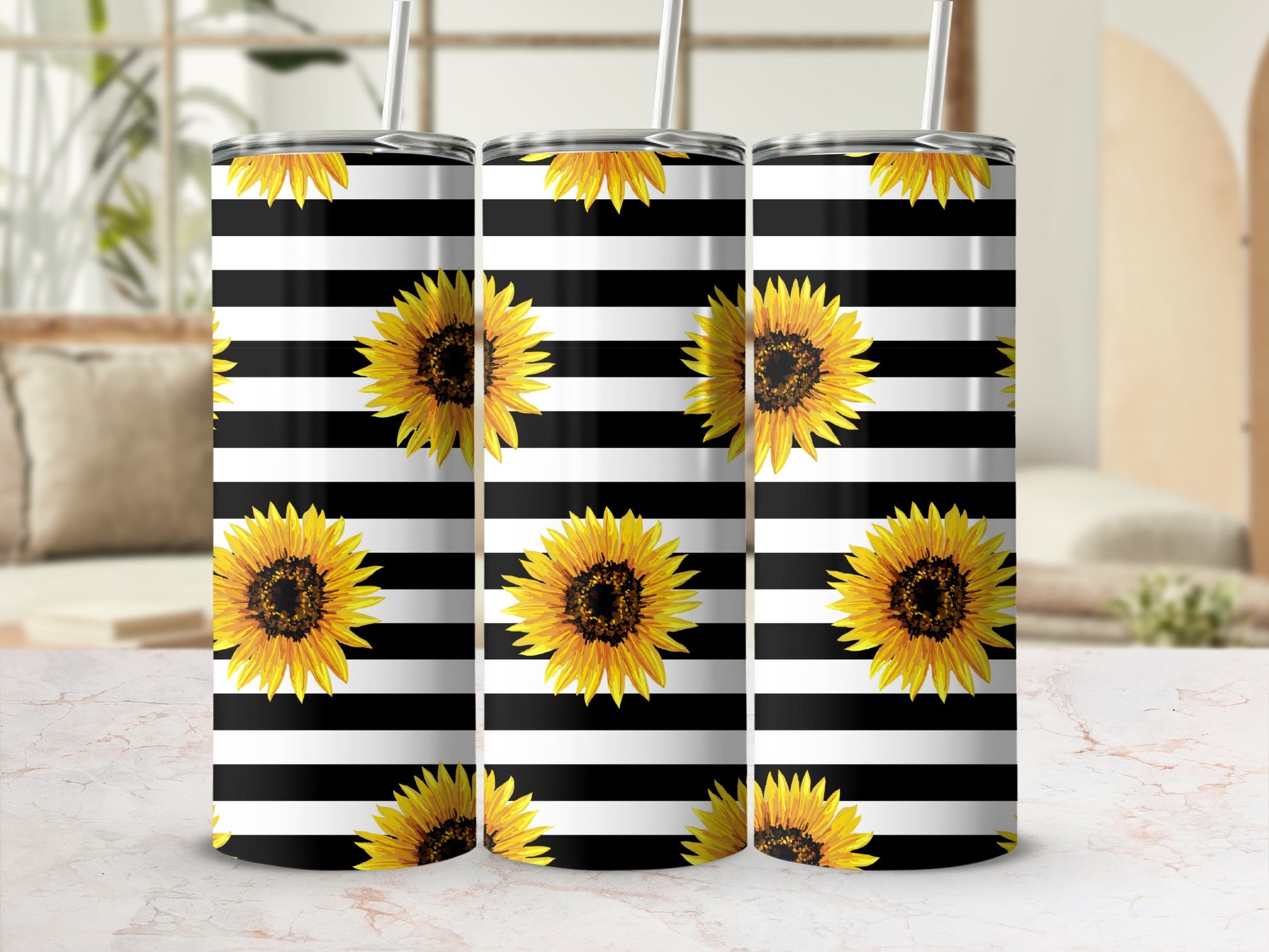 Three tumblers with black and white stripes and sunflowers.