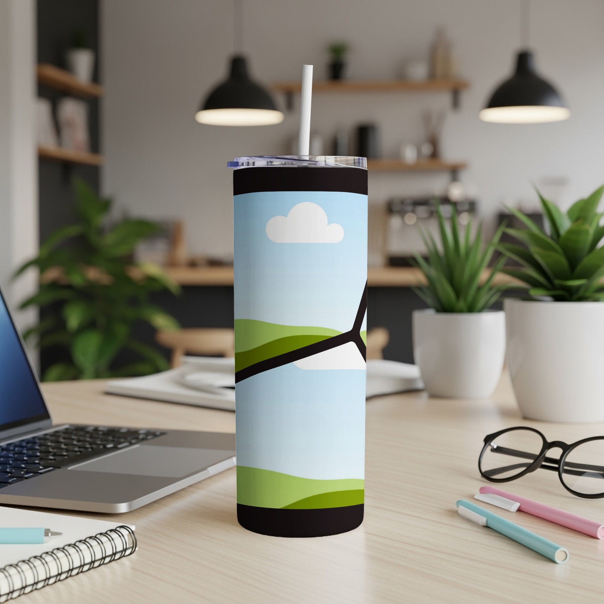 Tumbler with sky, clouds, and rolling green hills graphic and white straw.