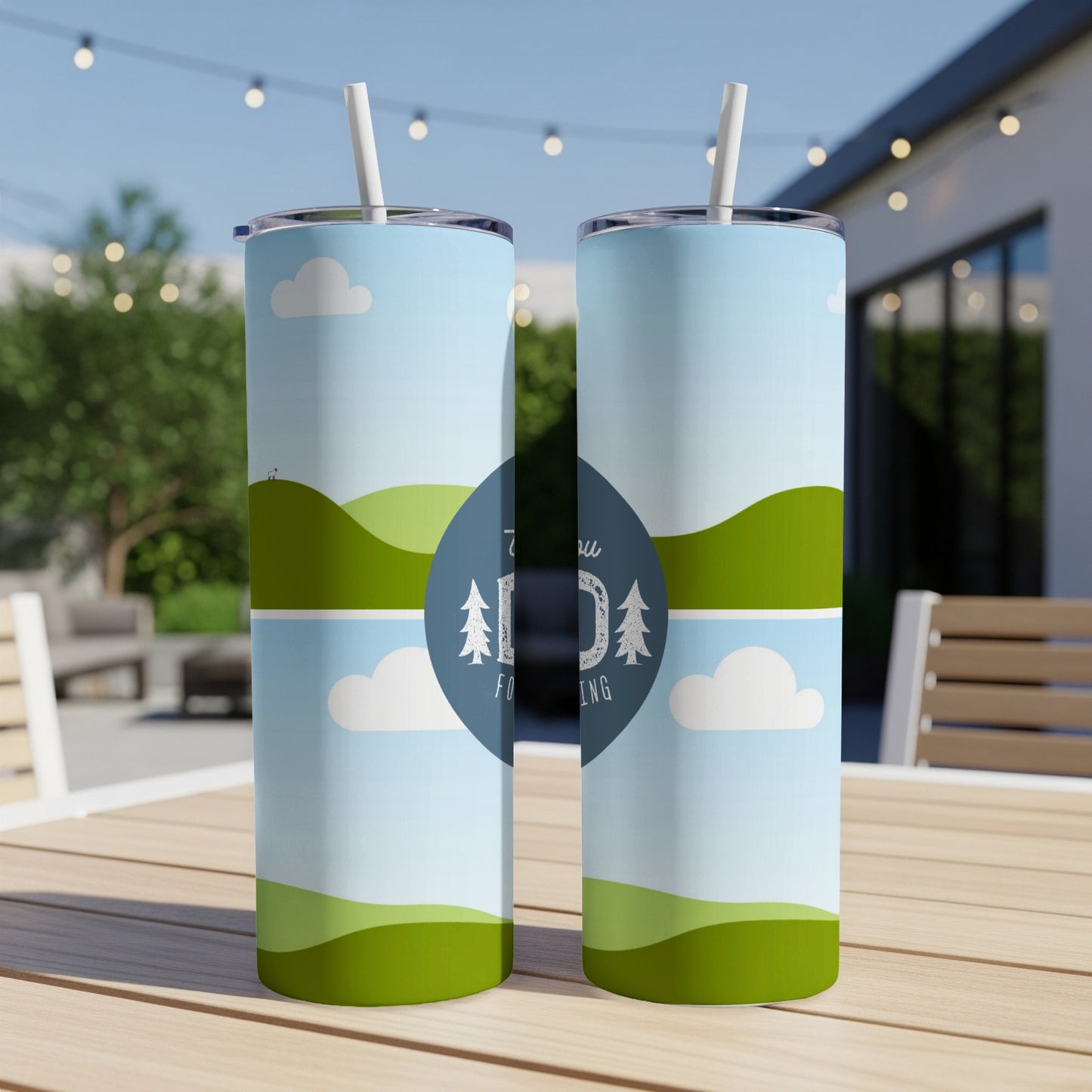 Two tumblers with a scenic landscape design and a blue circle with trees and text.