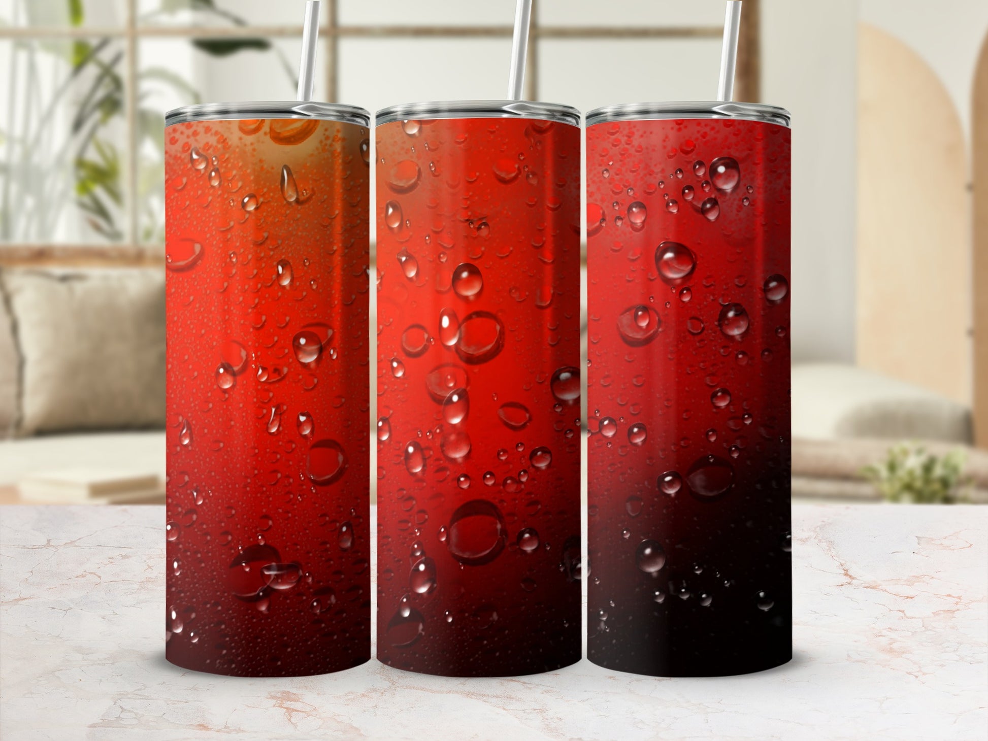 Three red gradient tumblers with water condensation and straws.