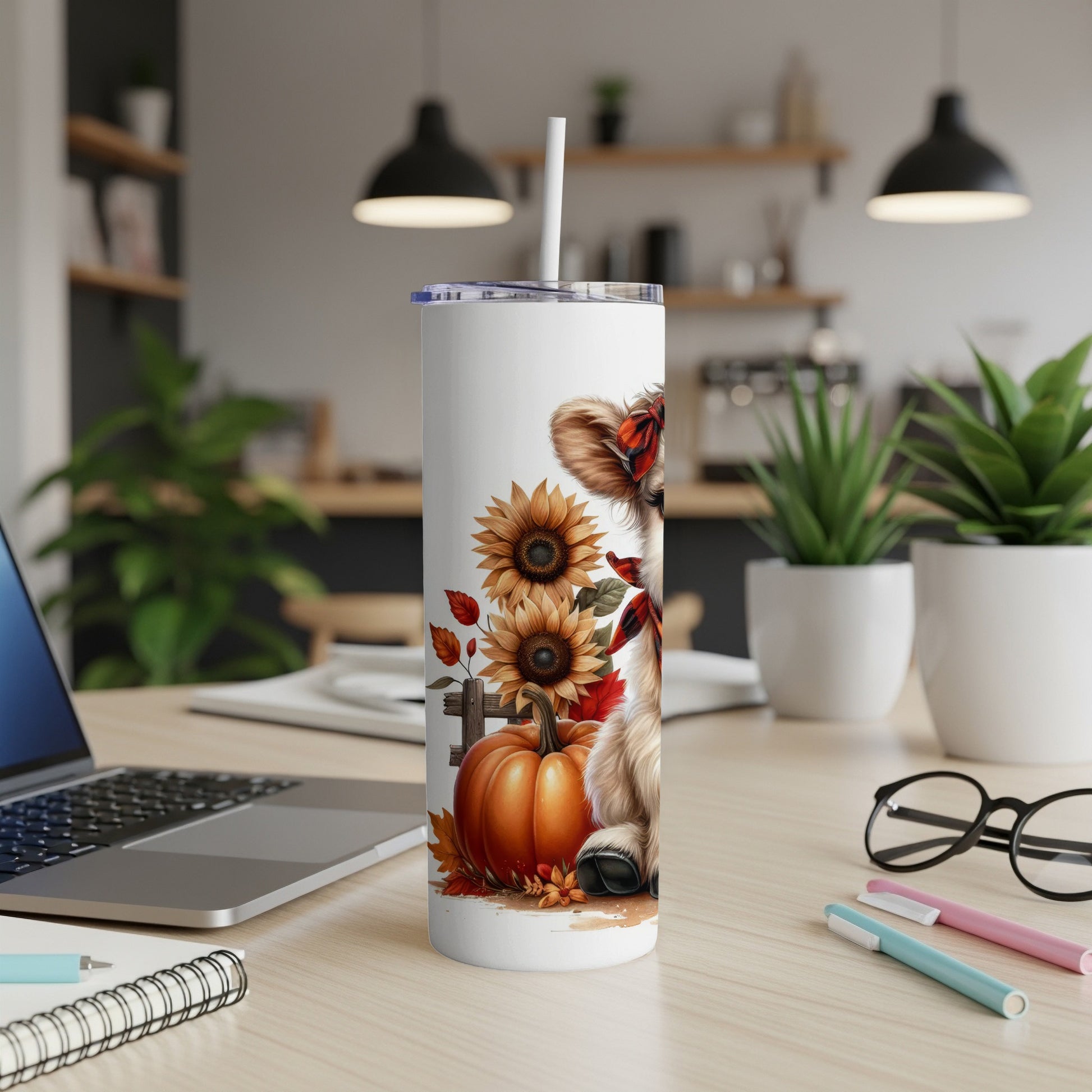 White tumbler with a cartoon cow, sunflowers, and pumpkin design.