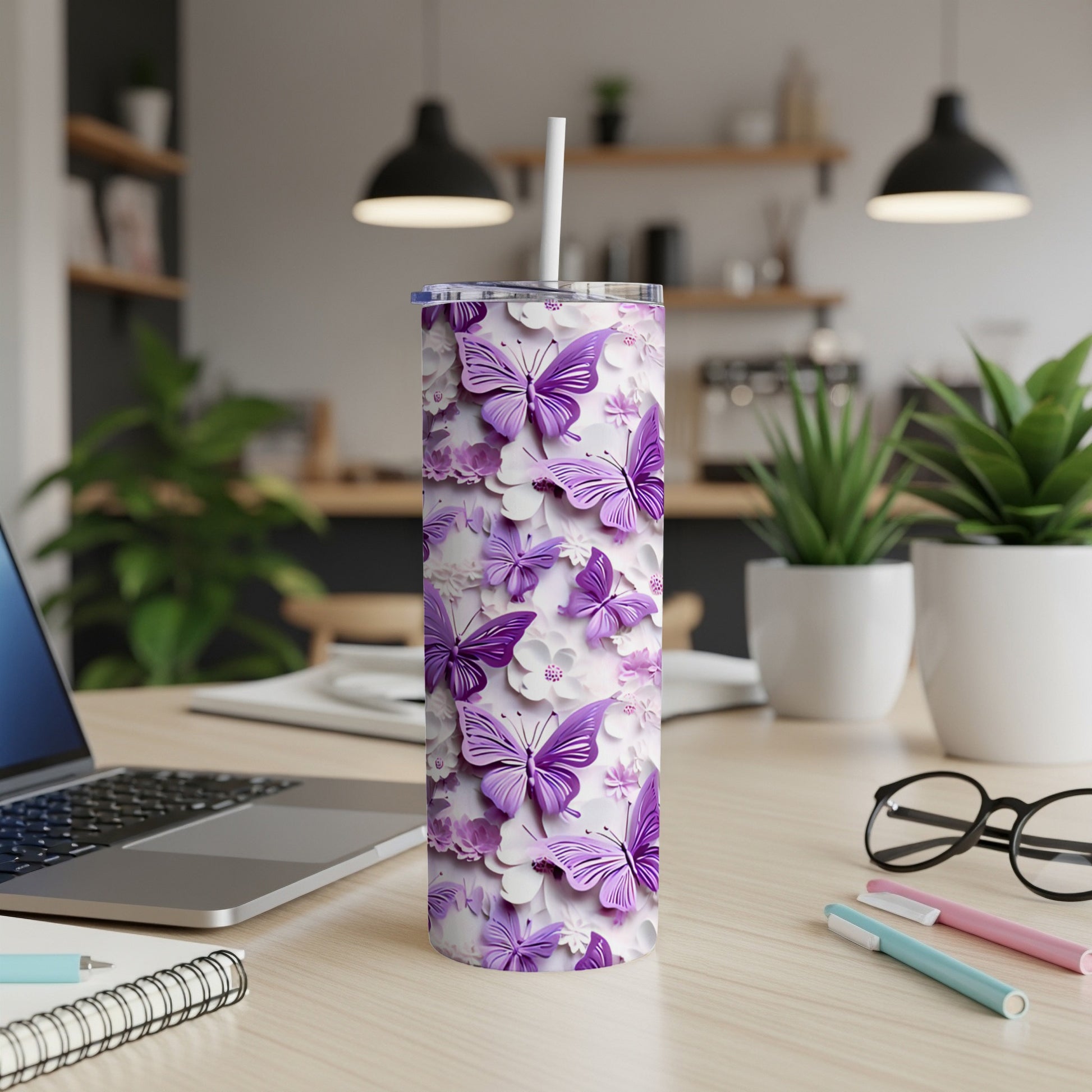Purple butterflies and flowers decorate a white insulated tumbler with straw.