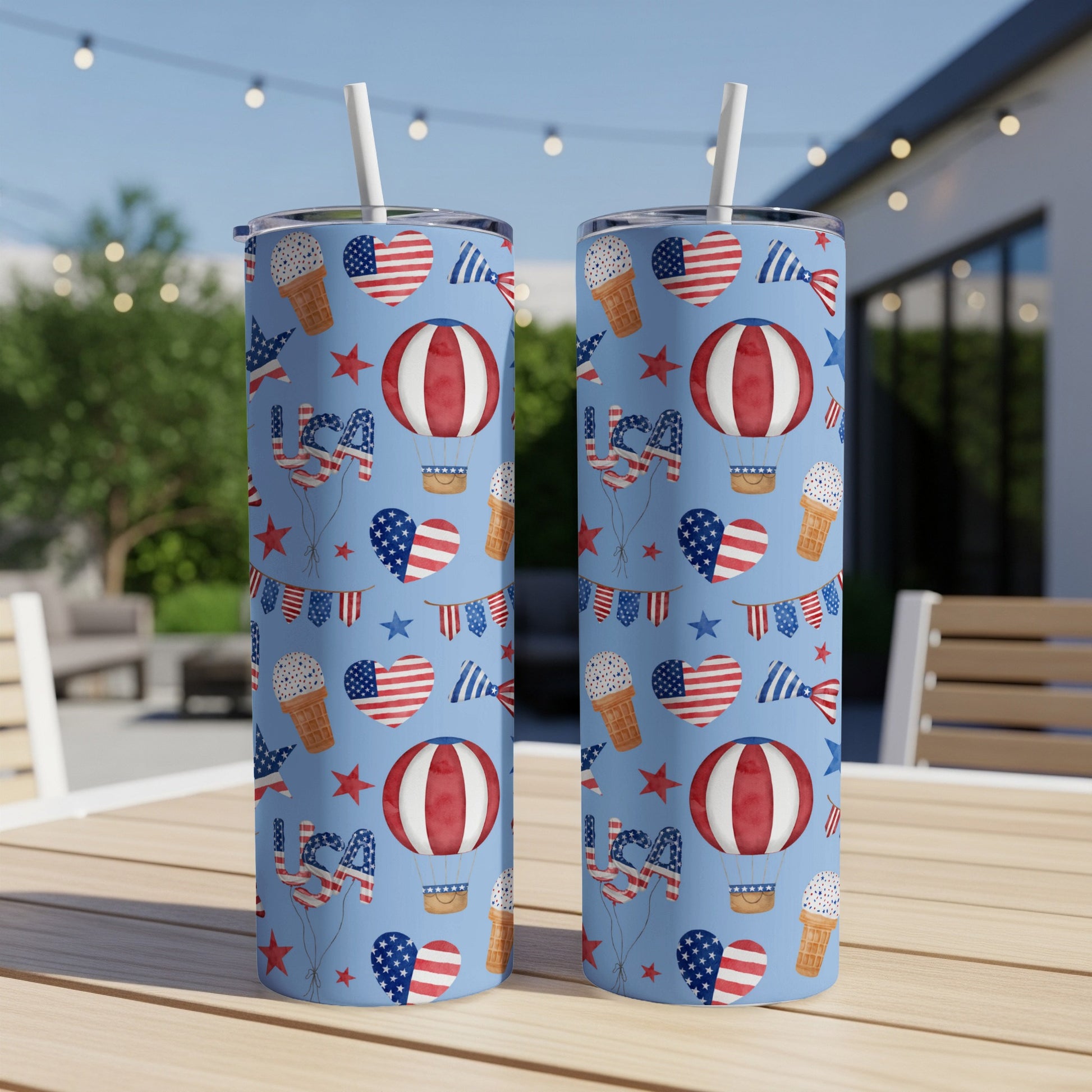 Two tumblers with patriotic Fourth of July themed patterns, including hot air balloons and stars.