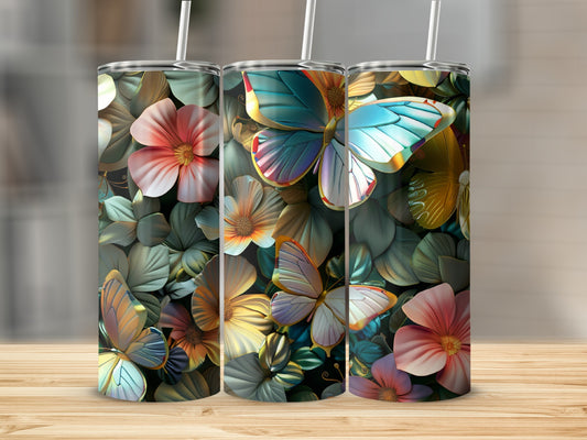 Three tumblers with floral and butterfly designs on a wooden surface.