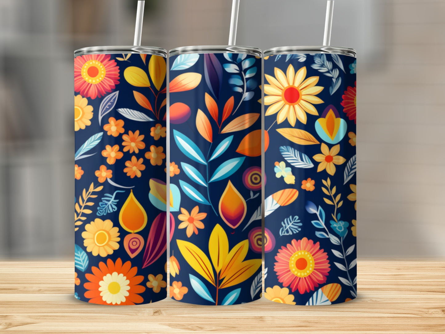 Three navy blue tumblers with a repeating floral pattern of colorful flowers and leaves.