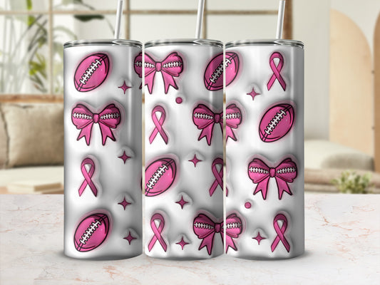 Pink footballs, bows, and ribbons on three white tumblers with straws.