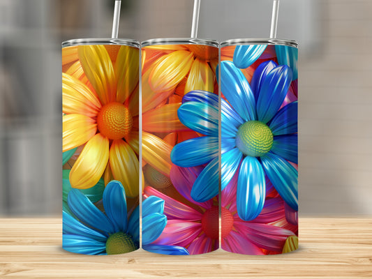 Three colorful floral tumblers with straws on a wooden surface.