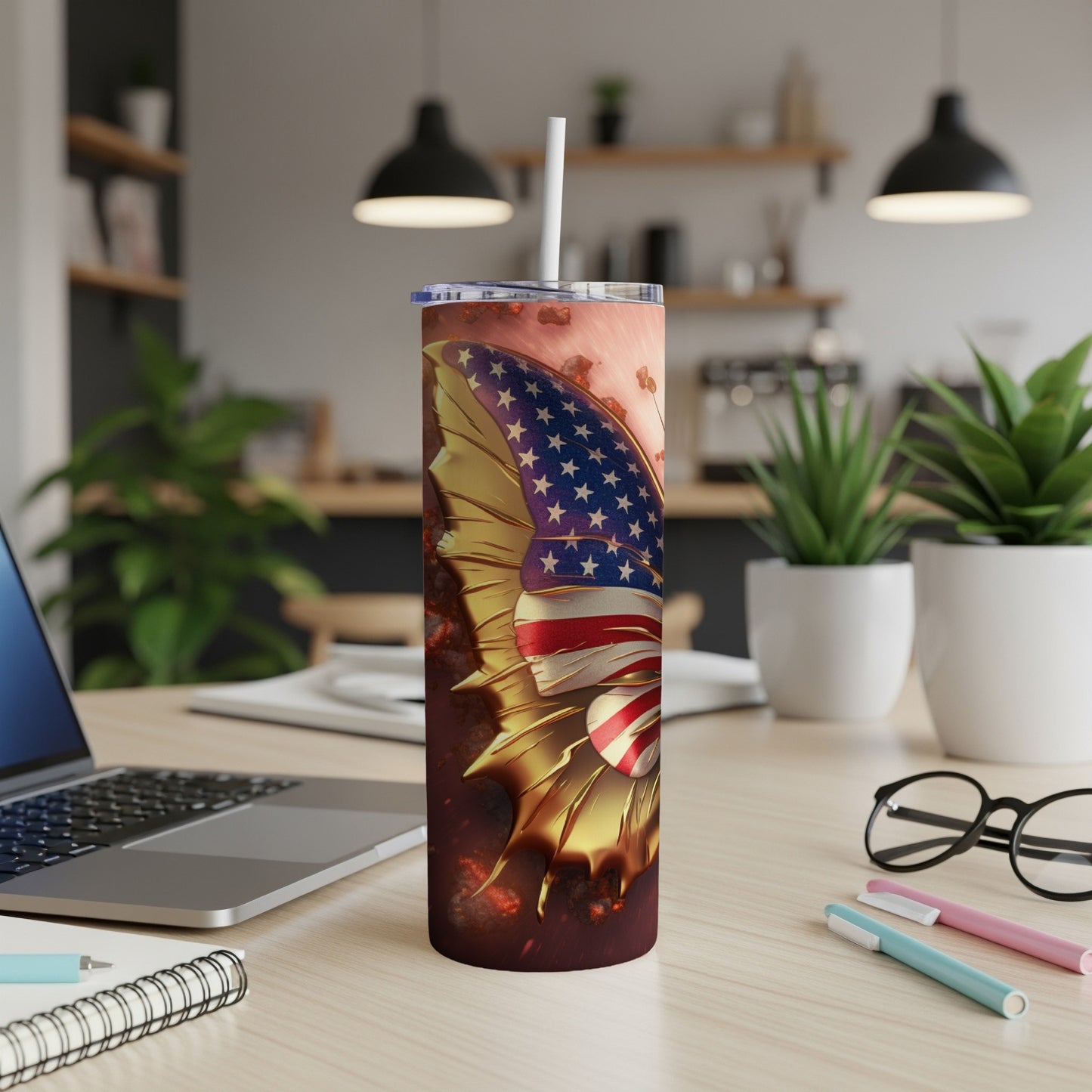 Tall tumbler with American flag wing design on a desk.