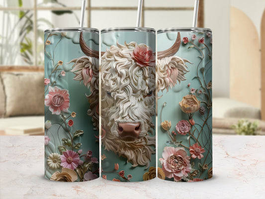 Floral Highland cow design on three tumblers against a soft, blurred background.