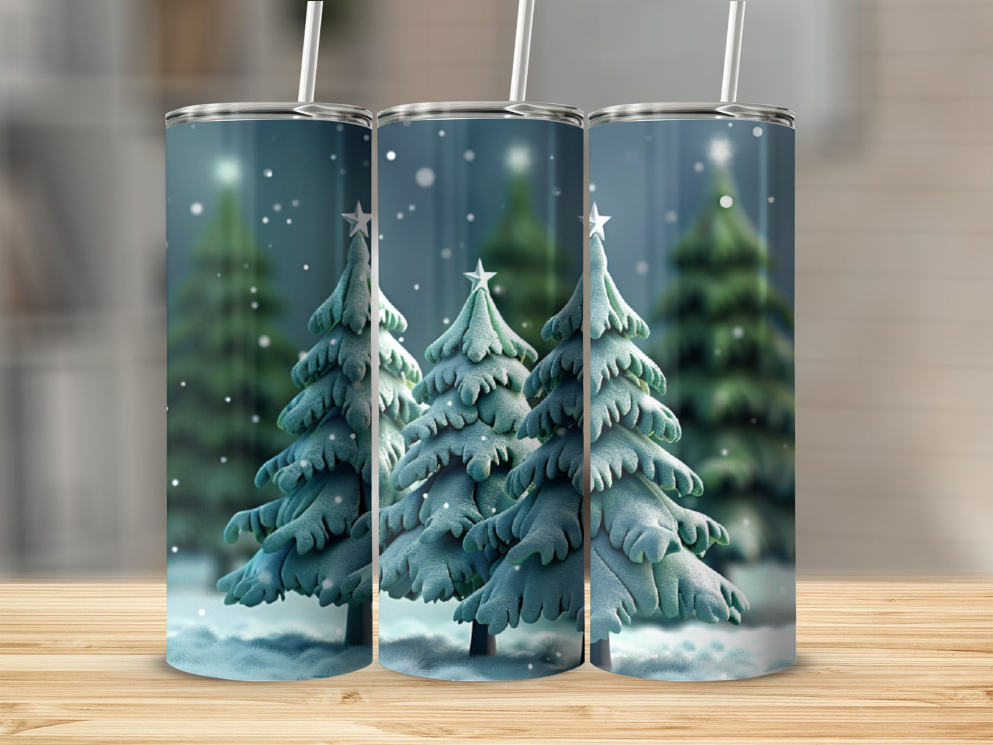 Three tumblers with a snowy Christmas tree design and straws.