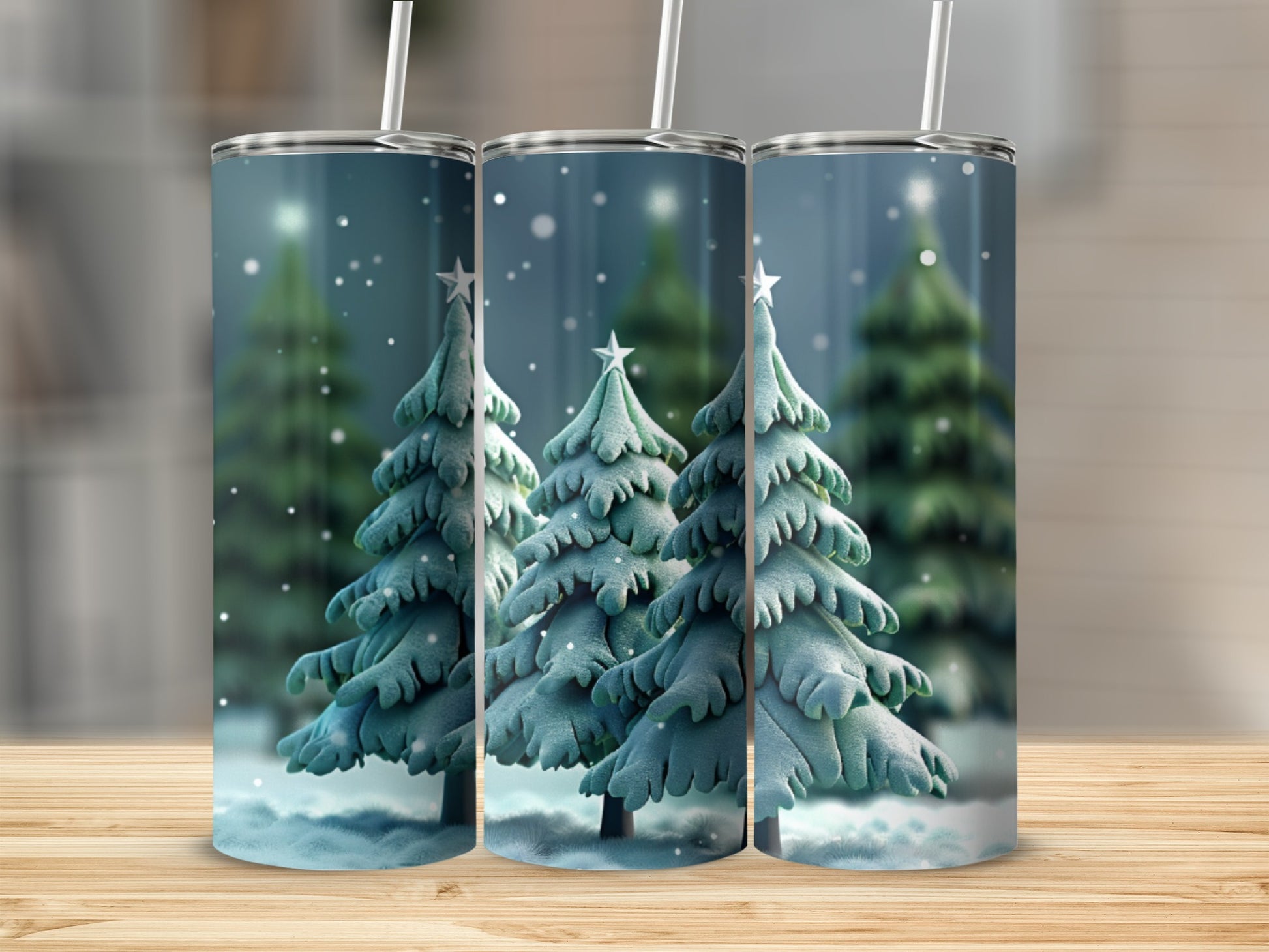 Three tumblers with a snowy Christmas tree design and straws.