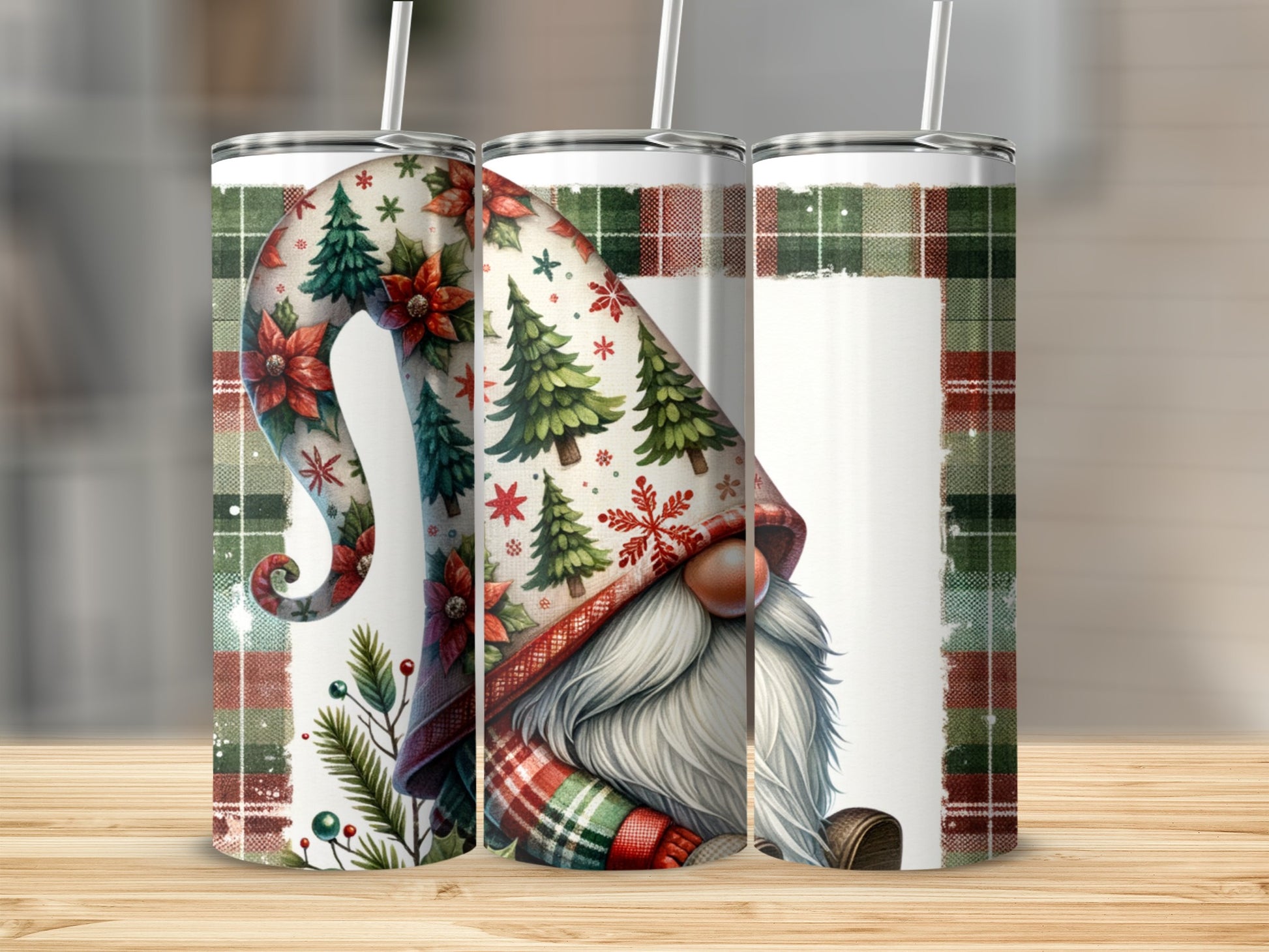 Three tumblers with a gnome and poinsettias design, against a plaid background.
