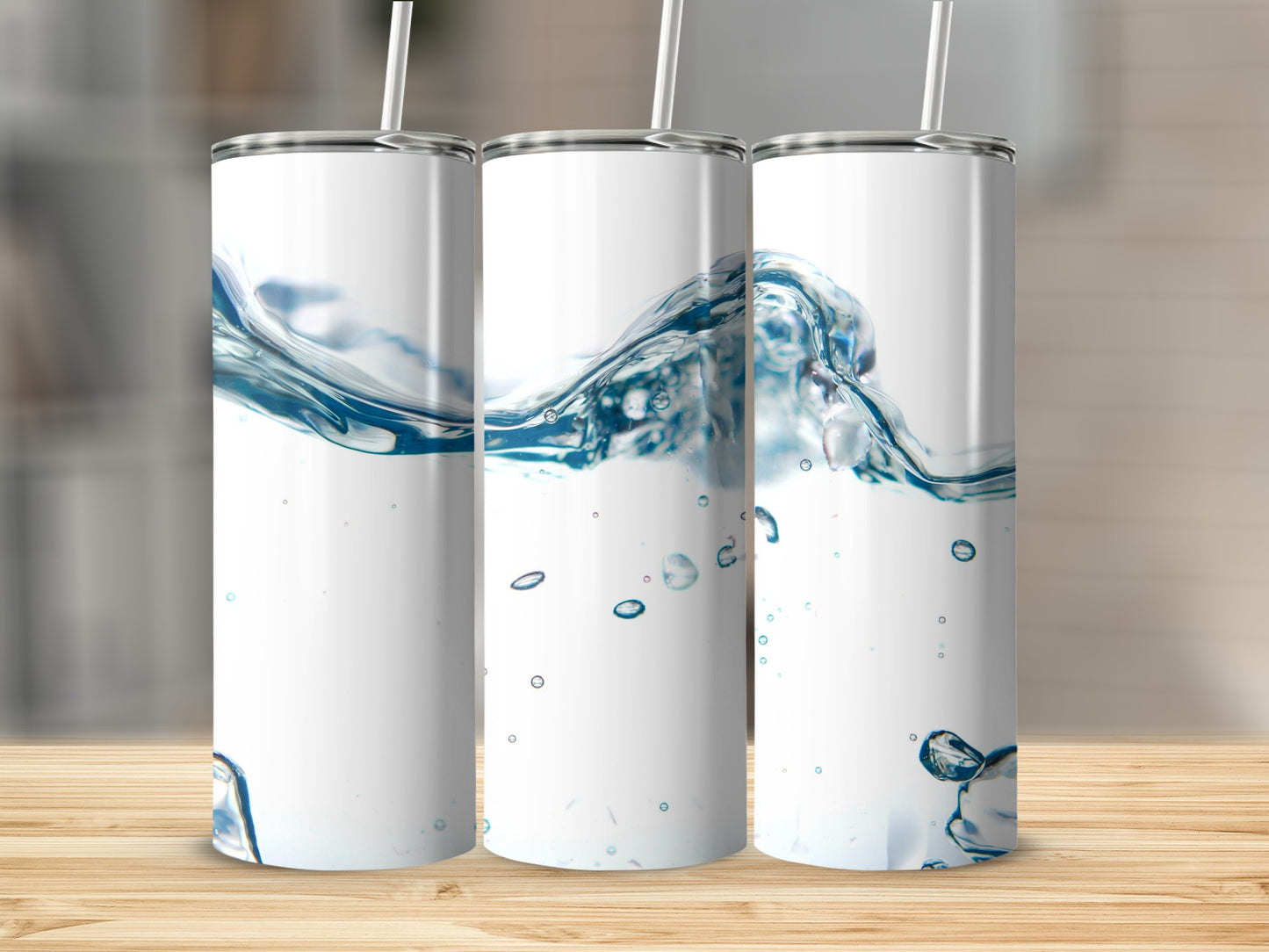 Three white tumblers with a water splash design and straws.