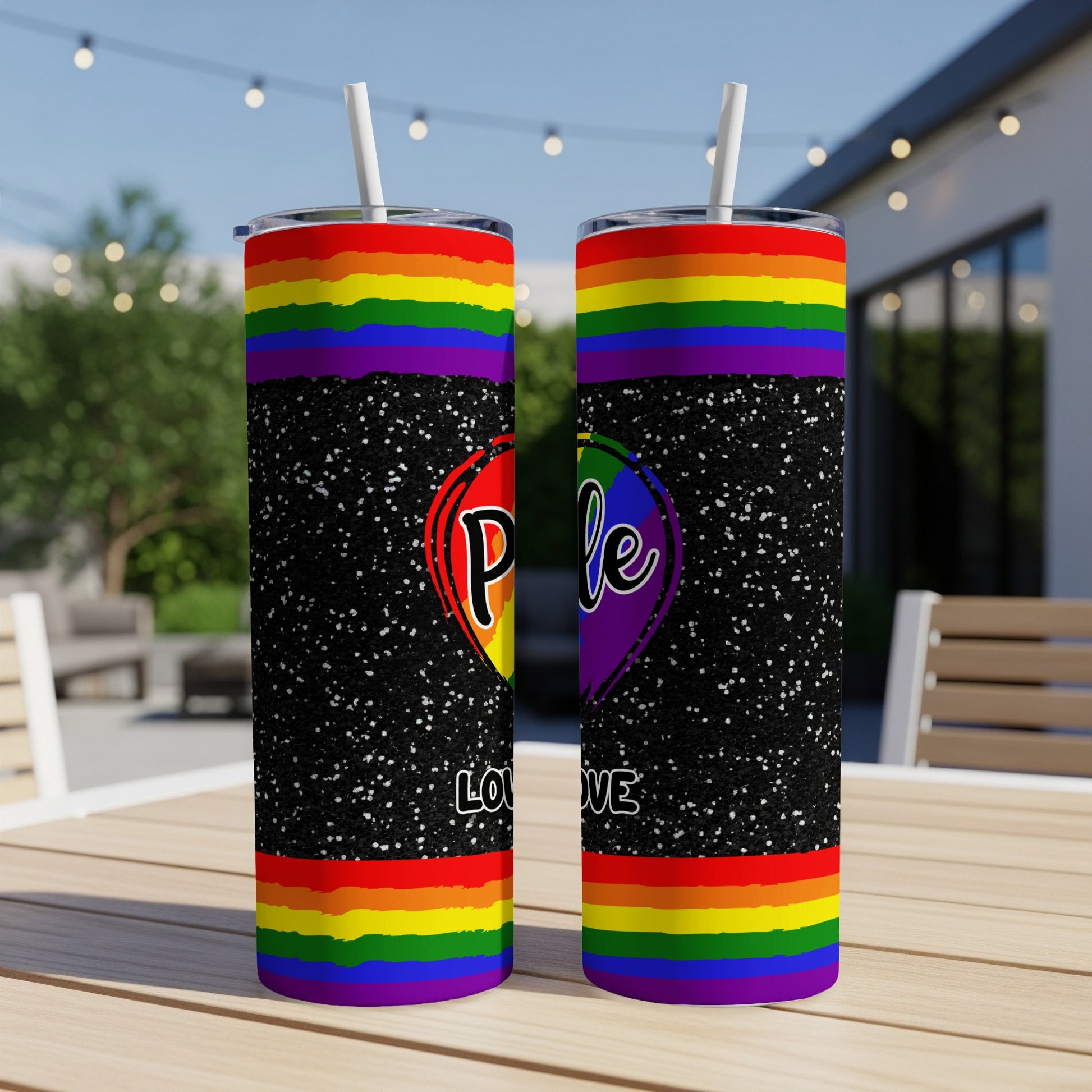 Rainbow pride heart tumbler with glitter on black background.