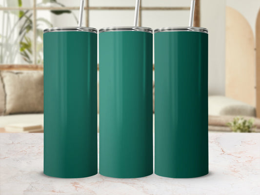 Three teal tumblers with straws arranged on a marble surface.