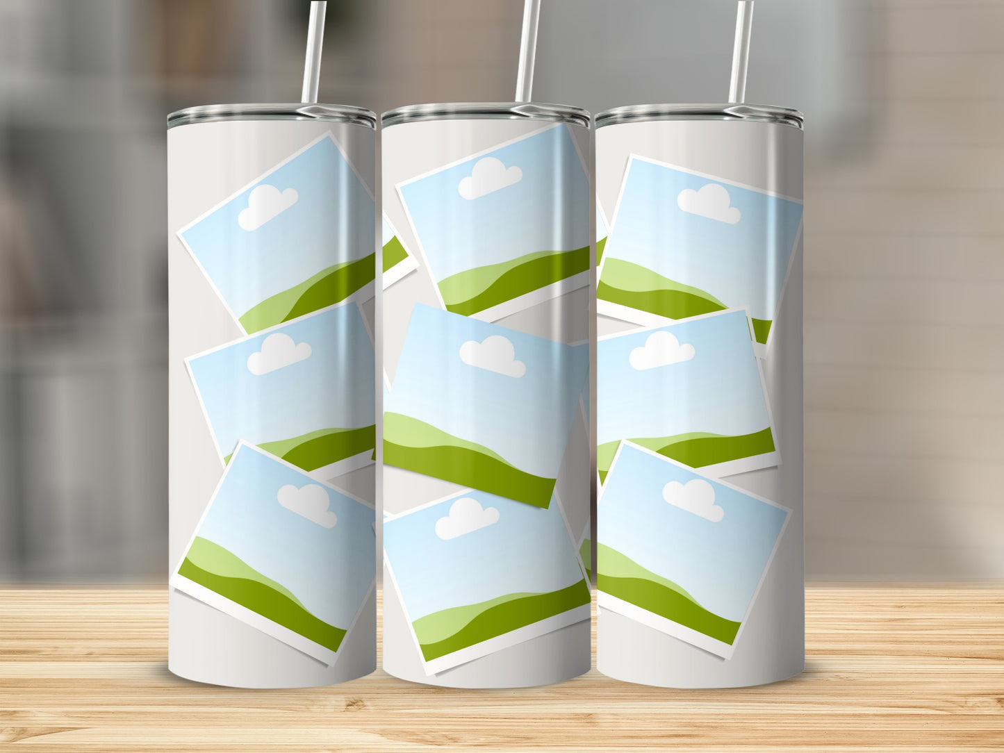 Three white tumblers with overlapping square photo frames displaying a landscape.