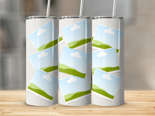 Three white tumblers with overlapping square photo frames displaying a landscape.