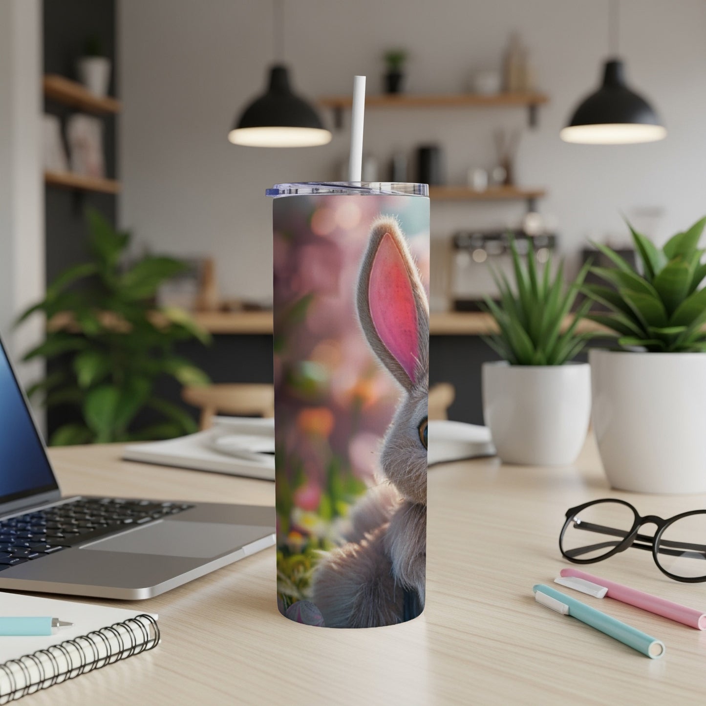 Close-up of a cute bunny peeking from behind a floral background on a tumbler.