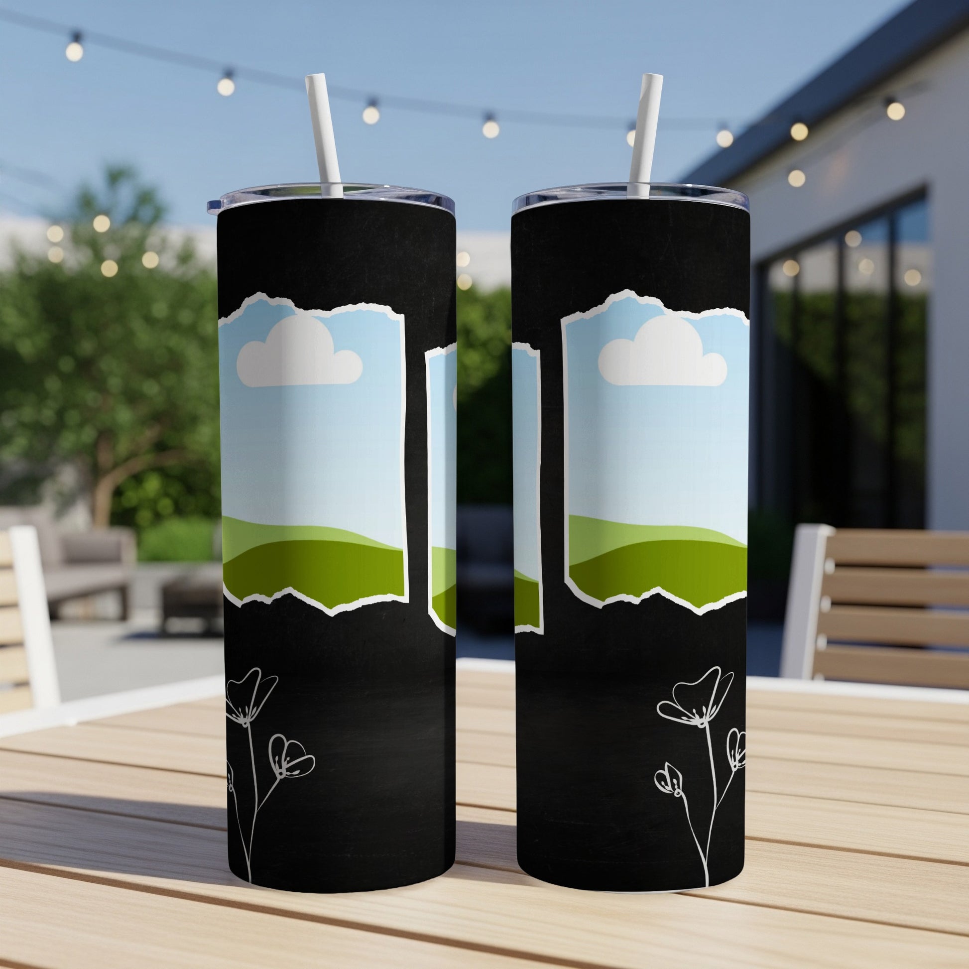 Two black tumblers with ripped paper effect showing sky, clouds, and green hills.