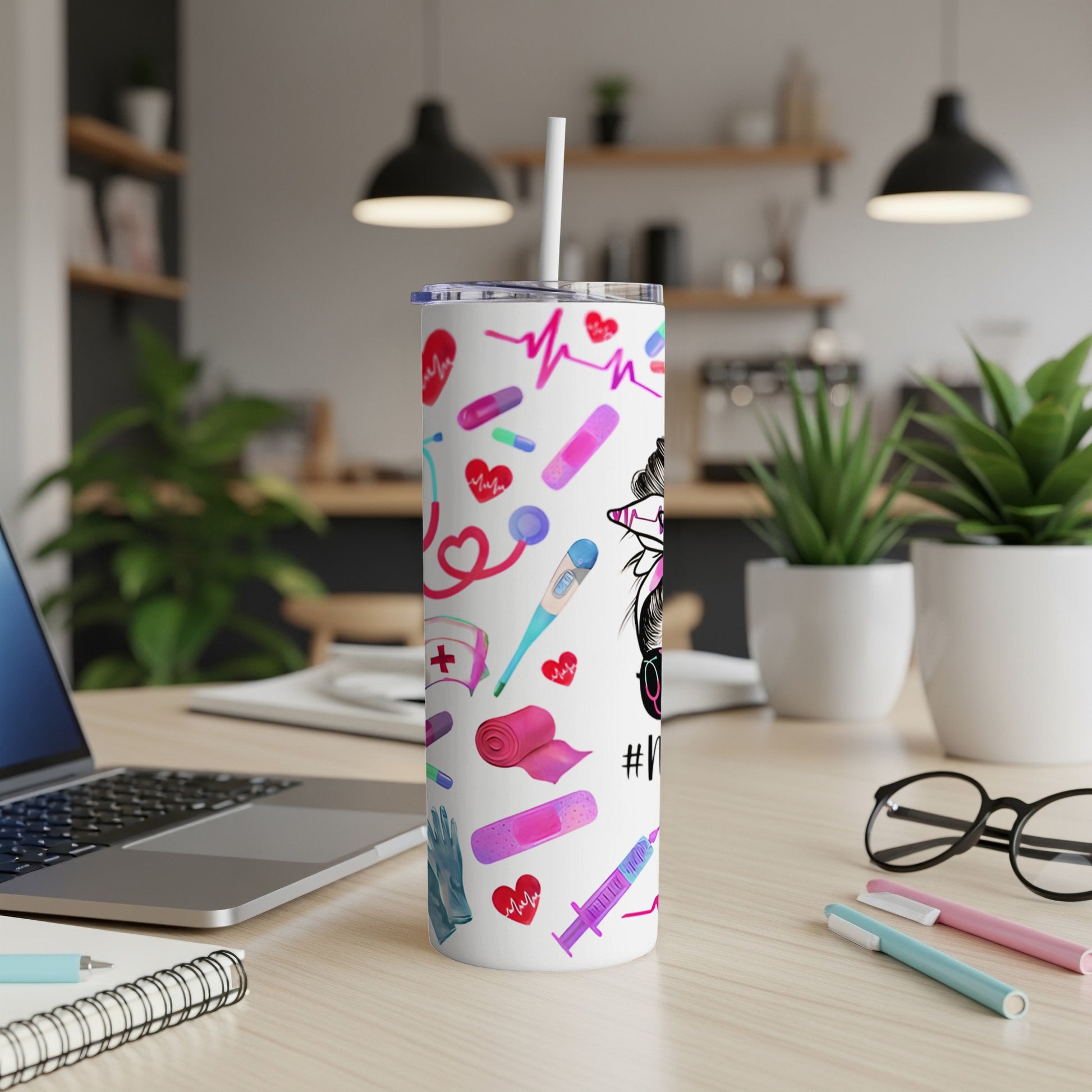 White skinny tumbler with medical icons and messy bun nurse graphic.